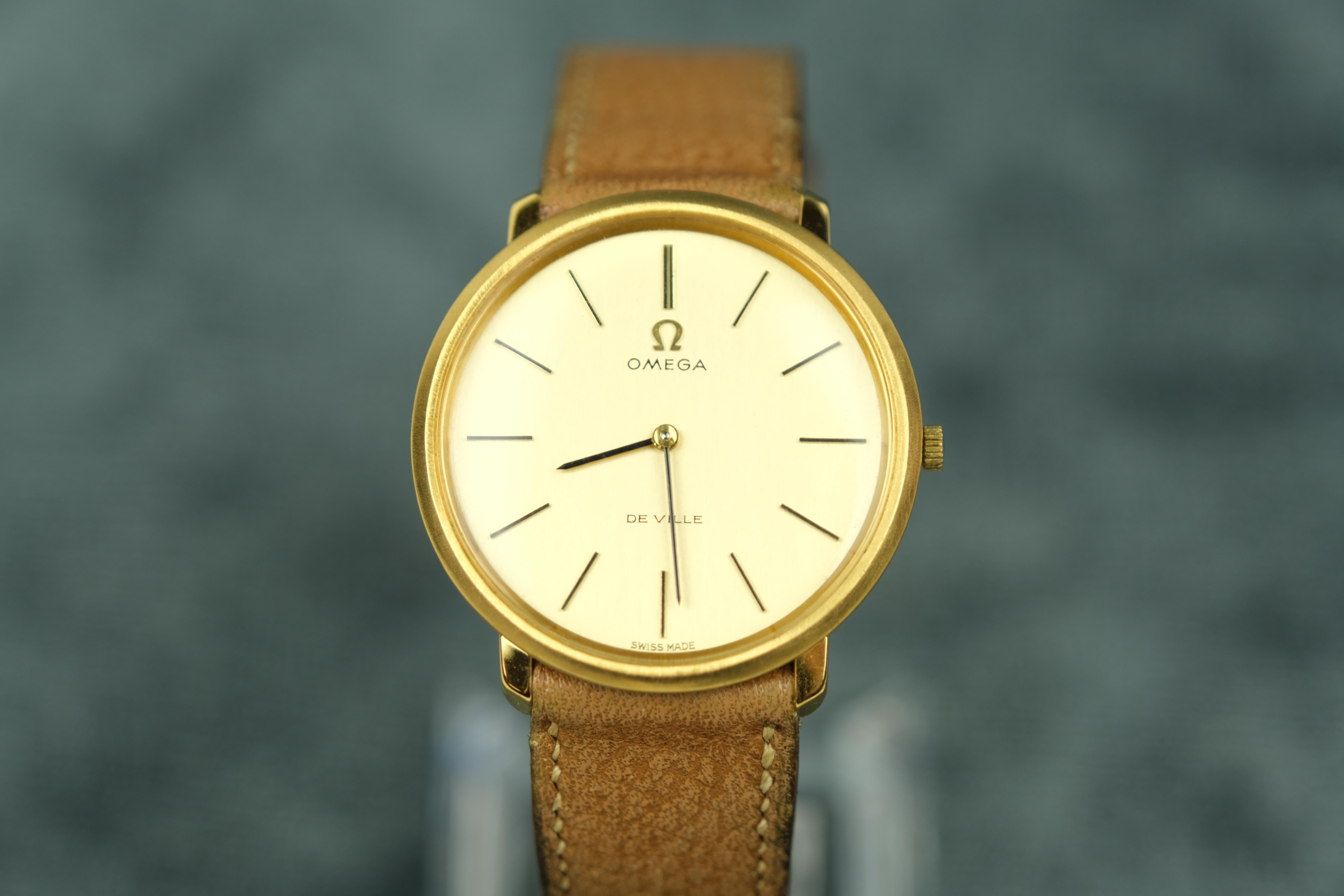Vintage Omega De Ville Gold Tone Stem Wind circa 1969.

BASIC INFO
Movement: Manual, Omega Cal.620, 17 Jewels
Estimated Production Year: 1969

CASE
Case Material: Gold Plate, Stainless Steel
Bezel Material: Gold Plate, Stainless