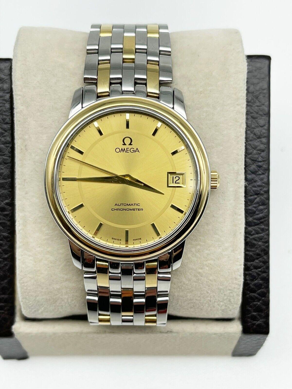 Style Number: 4300.11.00
Serial: 80371***
Year: 2005
Model: De Ville
Case Material: Stainless Steel 
Band: 18K Yellow Gold and Stainless Steel
Bezel: 18K Yellow Gold
Dial: Champagne
Face: Sapphire Crystal
Case Size: 34.7mm

Includes: 

-Omega Box,