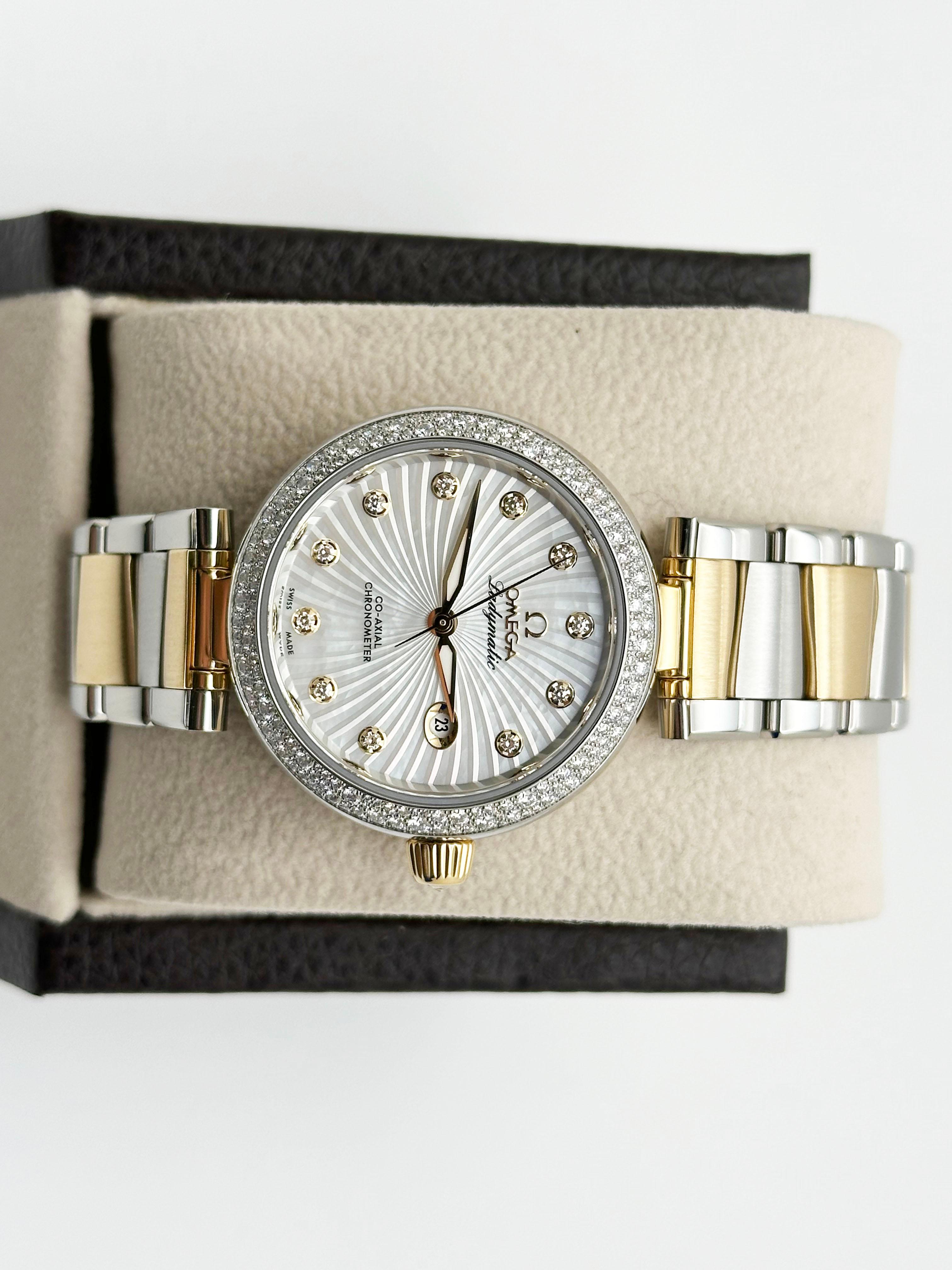 Style Number: 425.25.34.20.55.002

 

Model: Omega De Ville Ladymatic Automatic 

 

Case Material: Stainless Steel 

 

Band: 18K Yellow Gold & Stainless Steel 

 

Bezel: Original Factory Diamond Bezel 

 

Dial:  Original Mother of Pearl Diamond