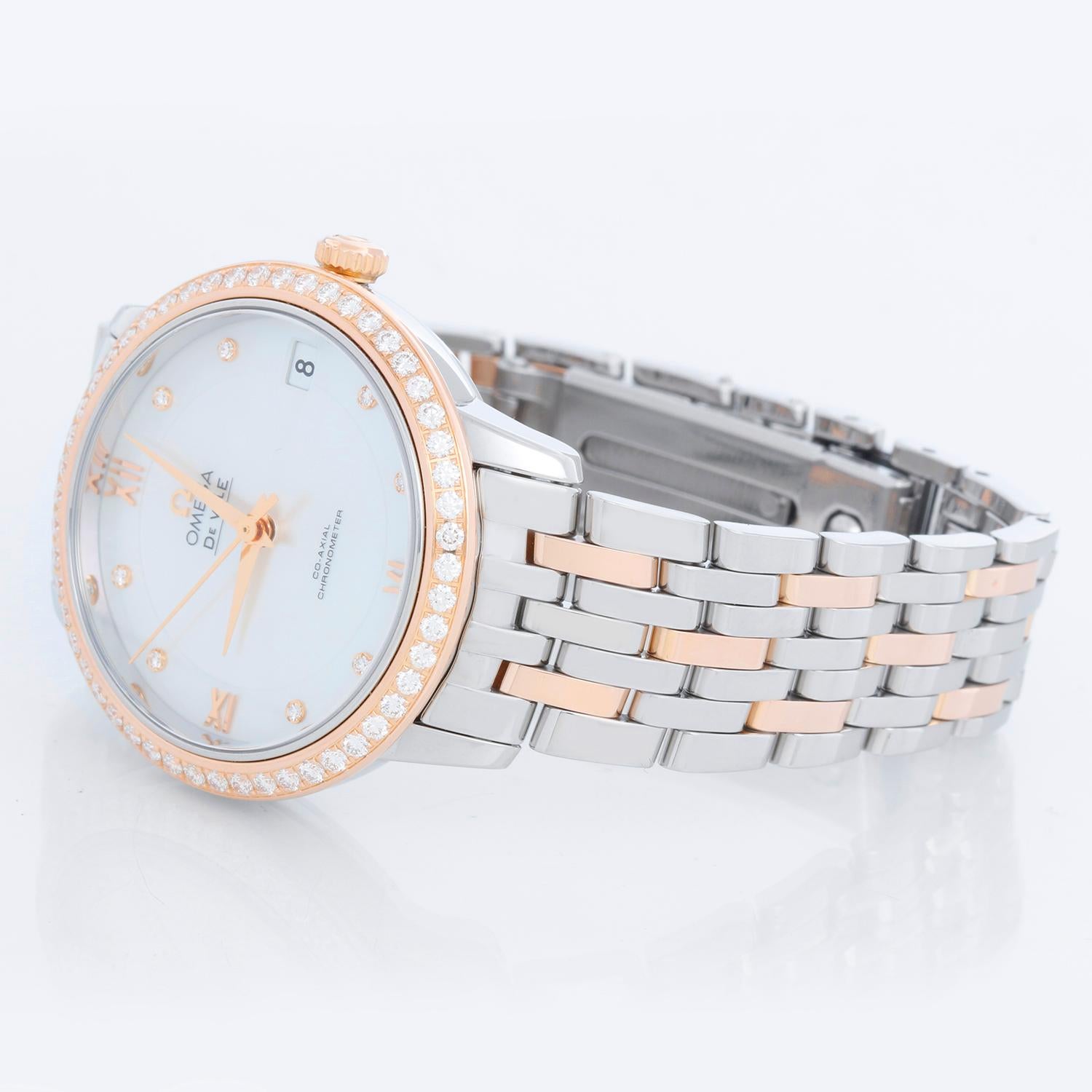 Omega De Ville Rose Gold & Stainless Steel  Women's Watch 424.25.33.20.55.002 - Automatic winding, sapphire crystal. Rose Gold & Stainless Steel Case (33mm) with factory diamond bezel. Factory Mother of Pearl dial with diamond hour markers. Rose