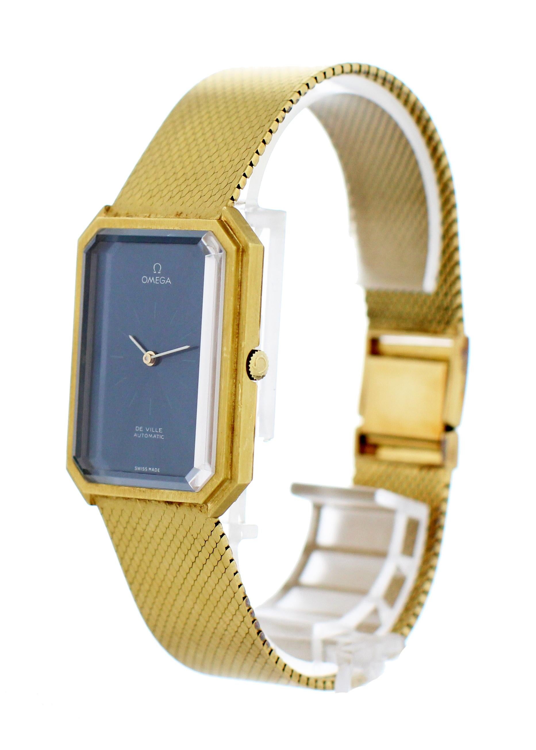 Omega De Ville Vintage 18k Yellow Gold Watch. 27mm 18k yellow gold case. Blue dial with yellow gold hands and indexes. 18k yellow gold smooth finish mesh bracelet with an adjustable jewelry clasp. Will fit up to a 7.25-inch wrist. Automatic