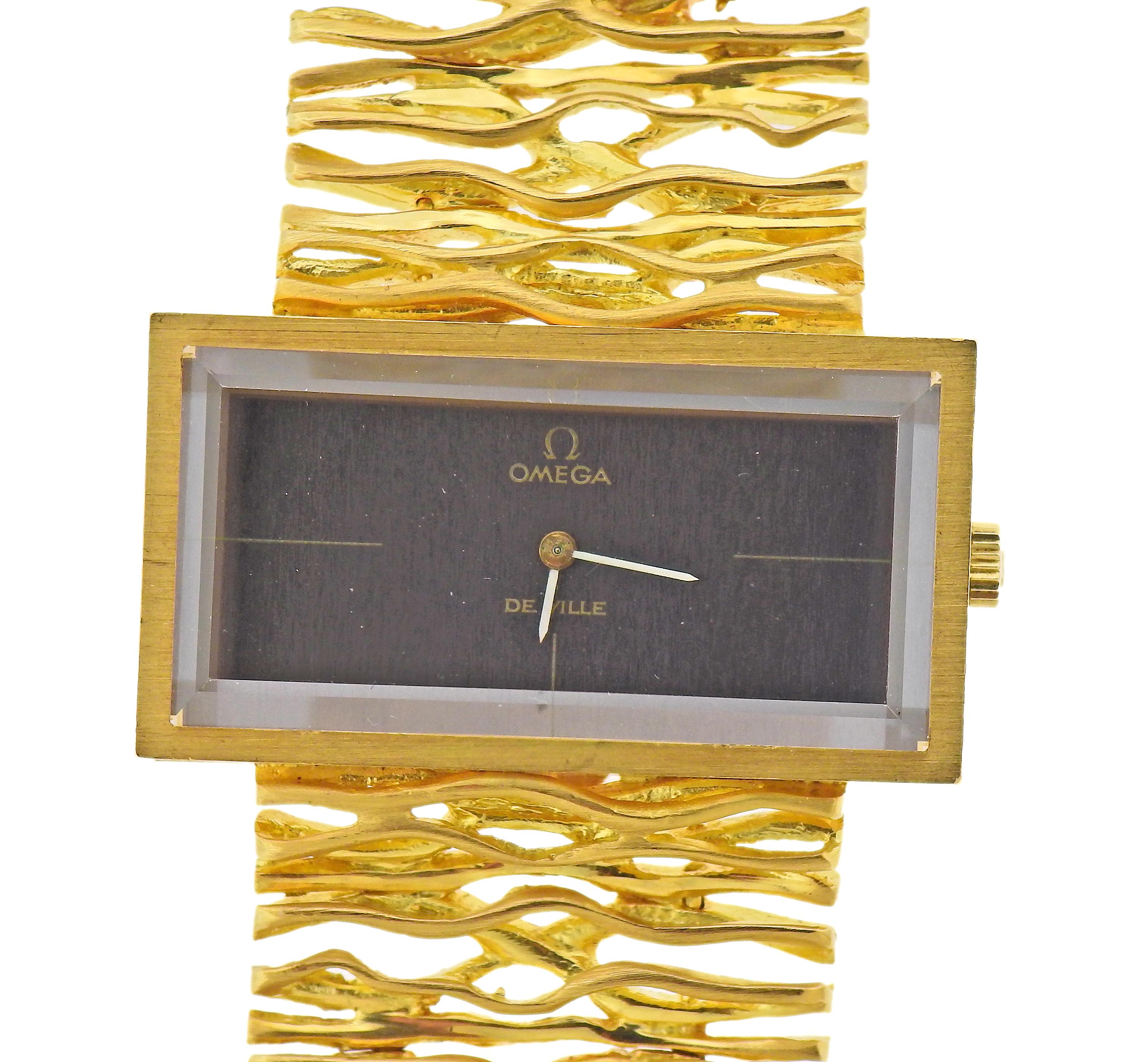 Vintage, circa 1970s 18k gold watch bracelet by Omega, with brown dial signed Omega. Bracelet is 7.25
