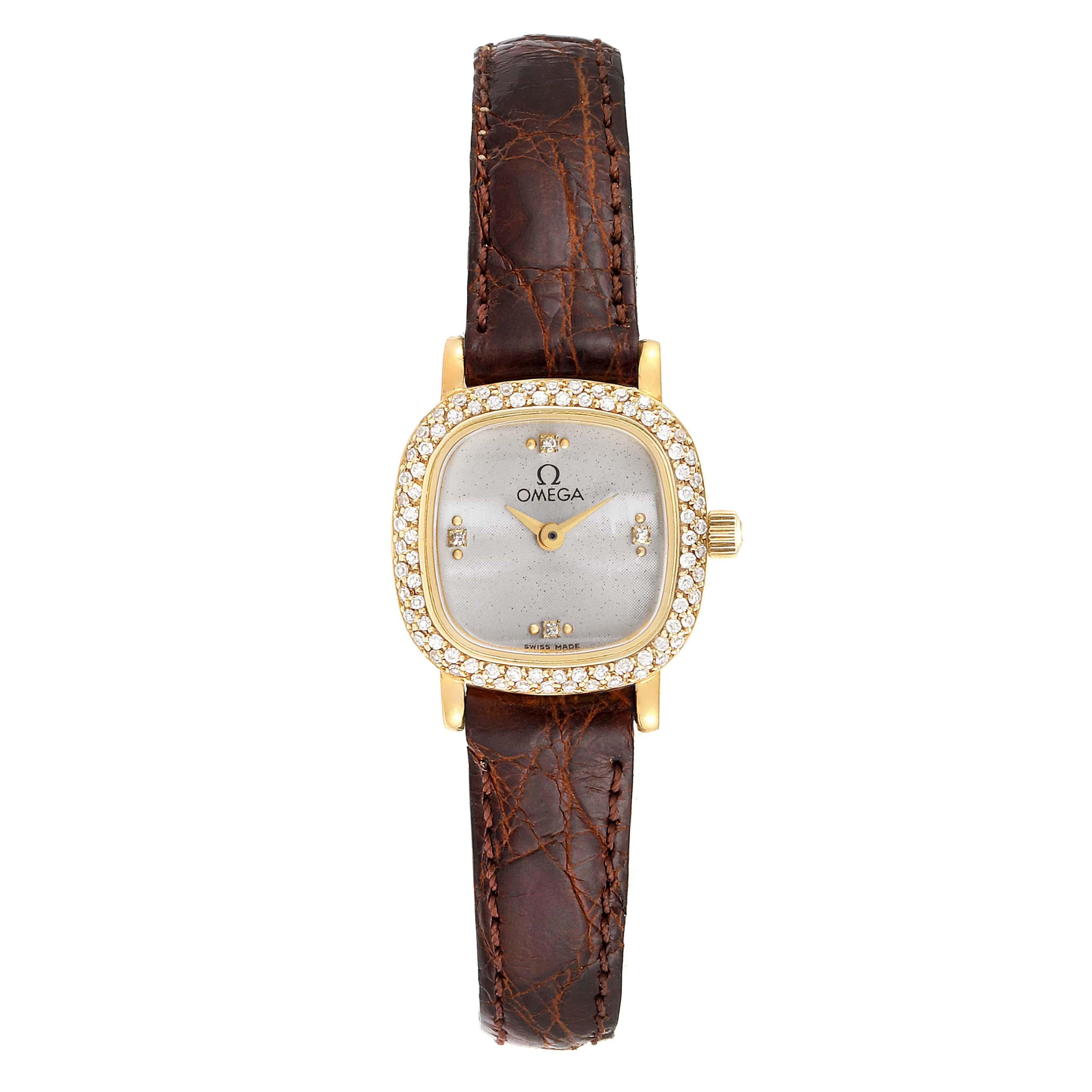 Omega DeVille Mini Yellow Gold Diamond Cocktail Ladies Watch 1450. Quartz movement. Yellow gold coushin case 18.5 x 18.5 mm. Yellow gold diamond bezel. Scratch-resistant sapphire crystal. Silver dial with diamond hour markers. Brown leather strap