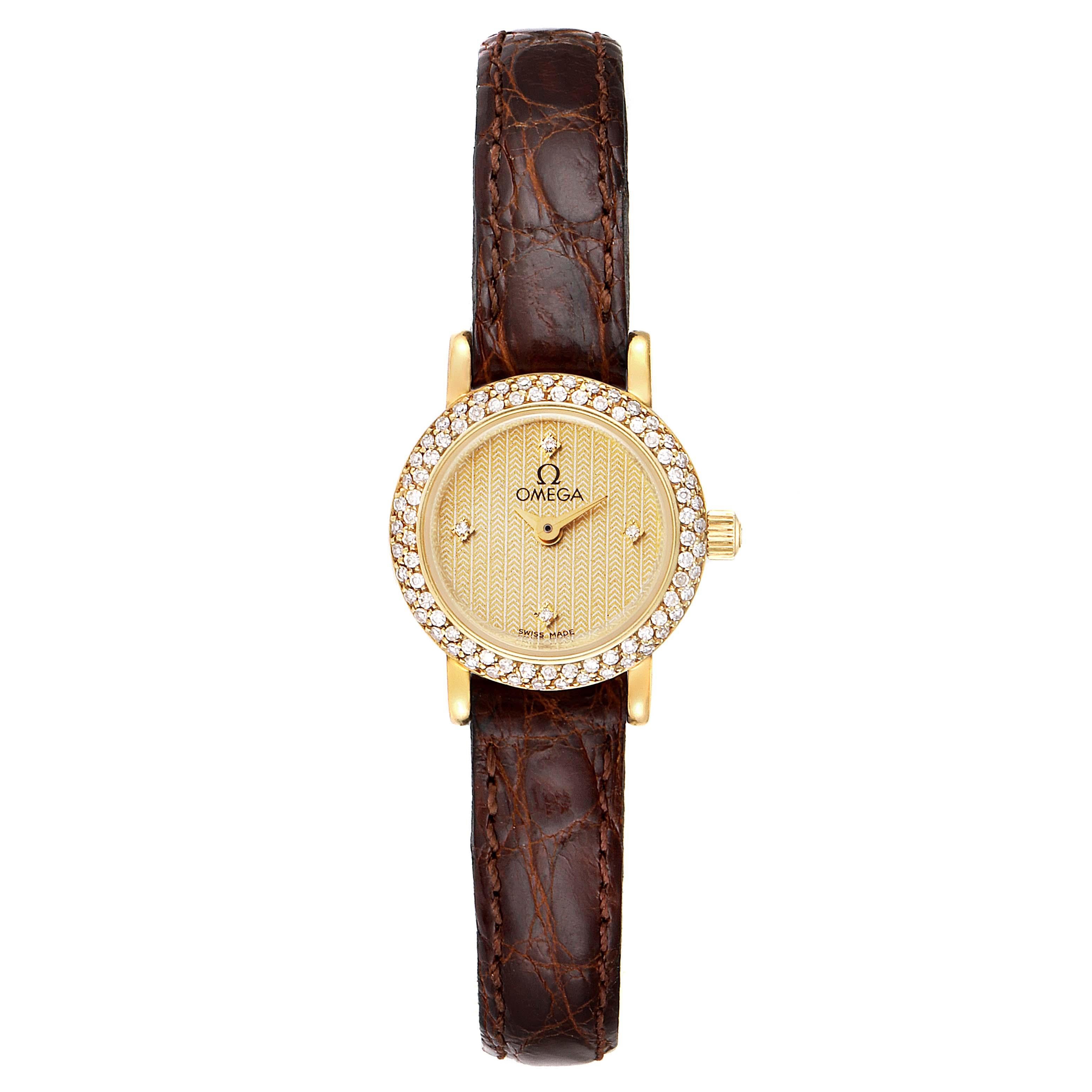 Omega DeVille Mini Yellow Gold Diamond Cocktail Ladies Watch 1450. Quartz movement. Yellow gold round case 18.5 mm in diameter. Yellow gold diamond bezel. Scratch-resistant sapphire crystal. Champagne dial with diamond hour markers. Brown leather