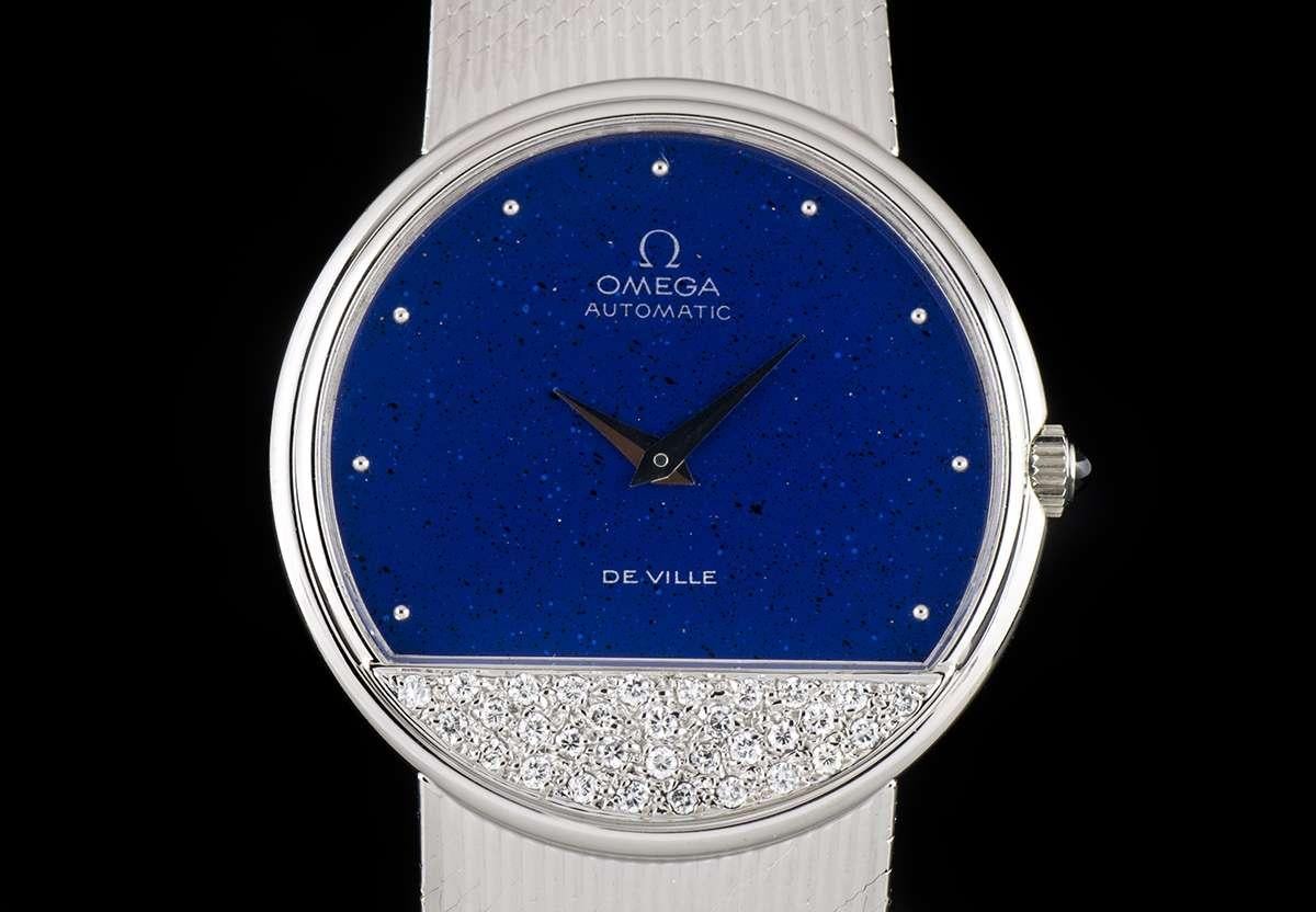 An 18k White Gold Omega DeVille Gents Wristwatch, lapis lazuli dial with 10 applied hour markers, a fixed 18k white gold stepped bezel, an 18k white gold case encrusted with approximately 32 round brilliant cut diamonds, an 18k white gold integrated