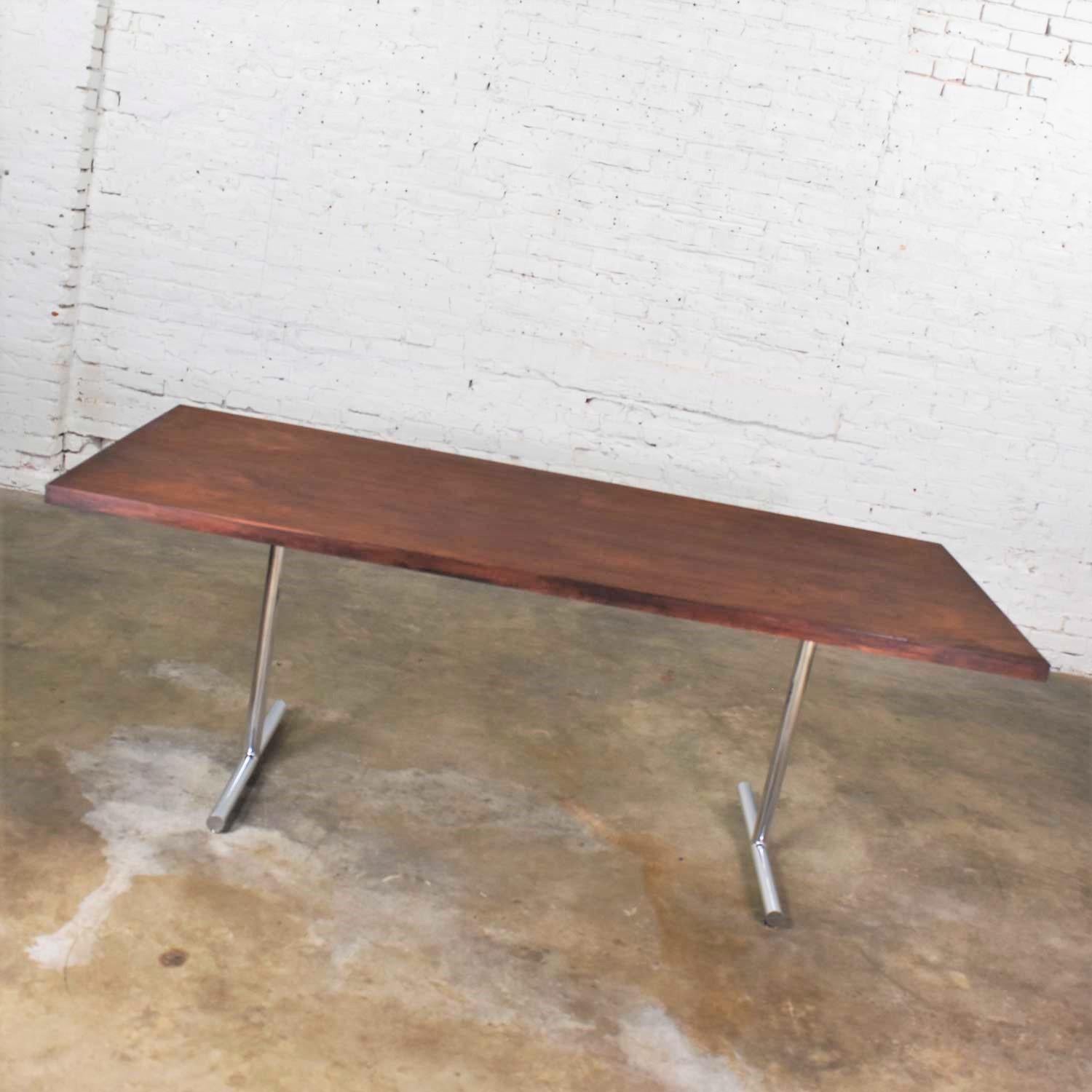 Handsome Omega dining table in rosewood and chrome designed attributed to Hans Eichenberger for Haussmann & Haussmann. The legs are marked with their maker which is Ernst Ries & Sohn. It is in wonderful overall vintage condition. The chrome base has