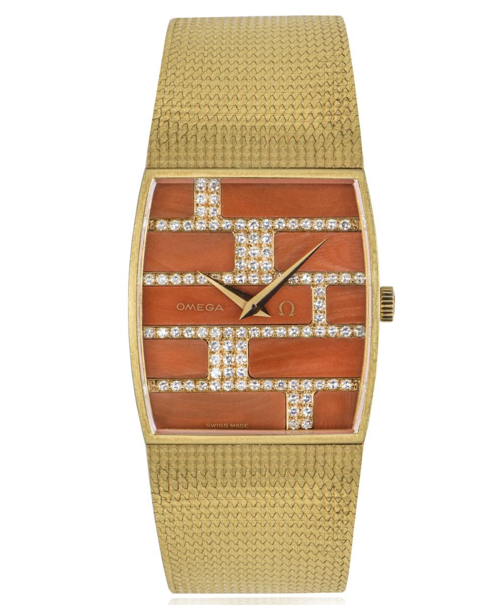 A yellow gold dress watch by Omega, featuring a rare coral and diamond-set dial in the style of brickwork; by far the hardest of the natural stone dials to come by. 

The bezel and integrated mesh bracelet are both yellow gold and is brought