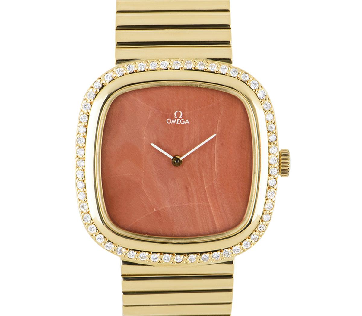 A yellow gold dress watch by Omega, featuring a rare coral stone dial; by far the hardest of the natural stone dials to come by (please note the dial is cracked which is reflected in the price). The bezel is set with 56 round brilliant cut diamonds.