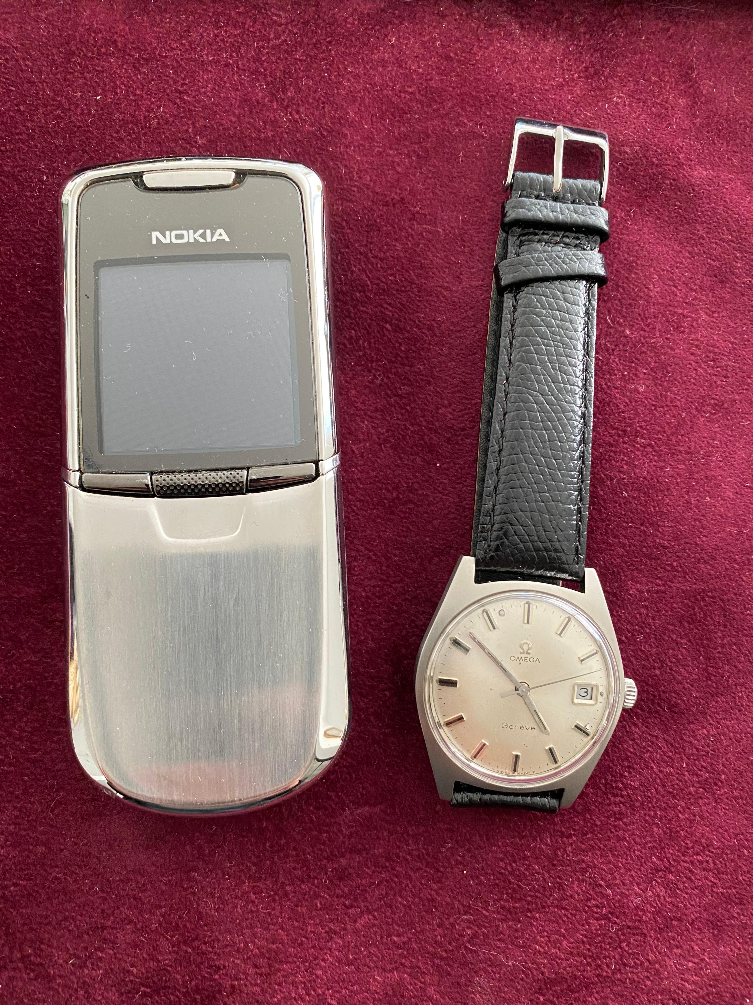 Omega (Genève) white face and black lather pattern strap. In mint condition. 
Omega Vintage Geneve Stainless Steel Automatic Watch. 
International collection : 1972 
Case material: Stainless Steel 
Vintage watch watchcase type: Screw-in 
Bracelet: