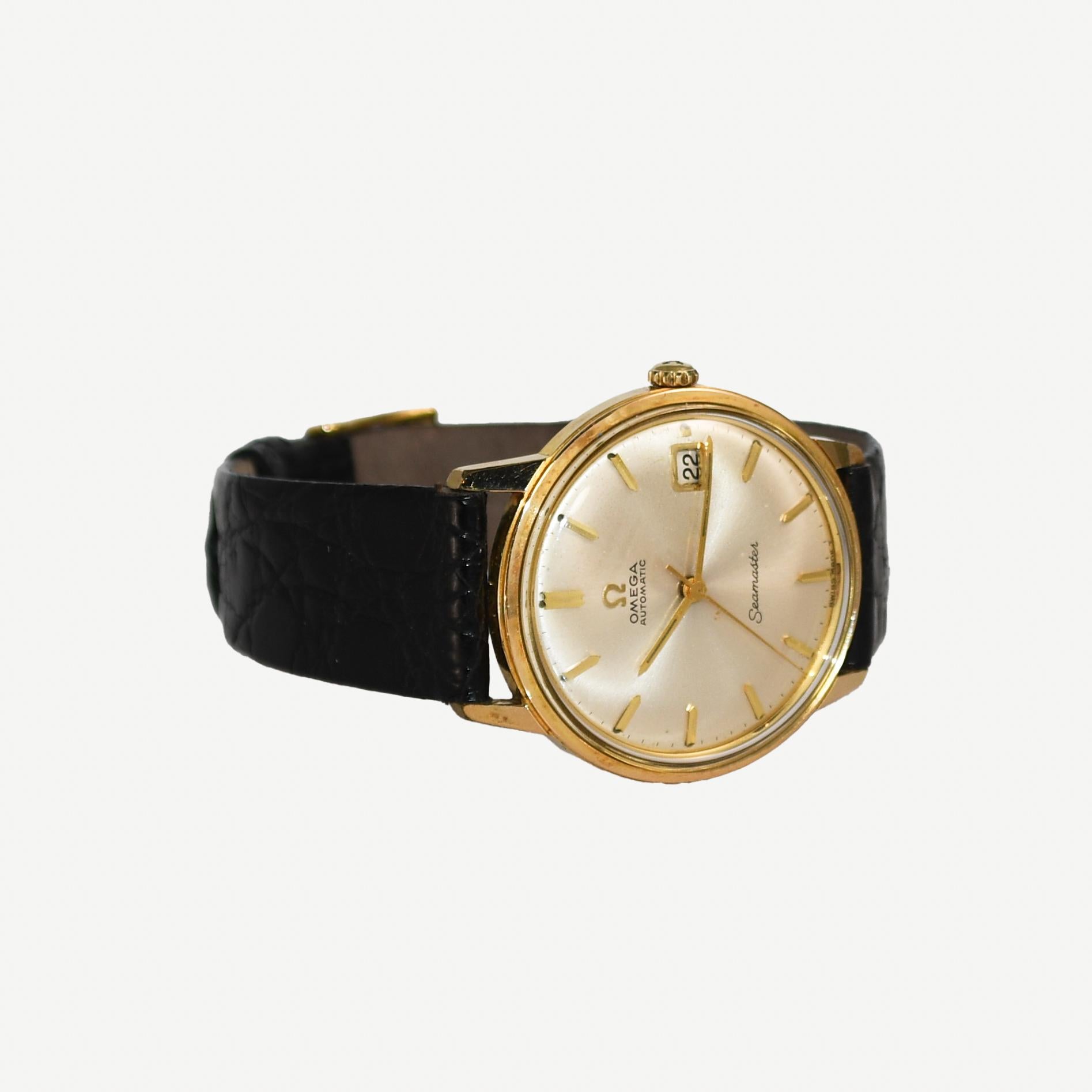 Men's Omega Seamaster Automatic wristwatch with date calendar display.
34mm case size. 24-jewel automatic movement, caliber 562.
Gold-plated upper case with stainless steel back.
Time tested by watch maker and keeps time. 
There is a small chip in