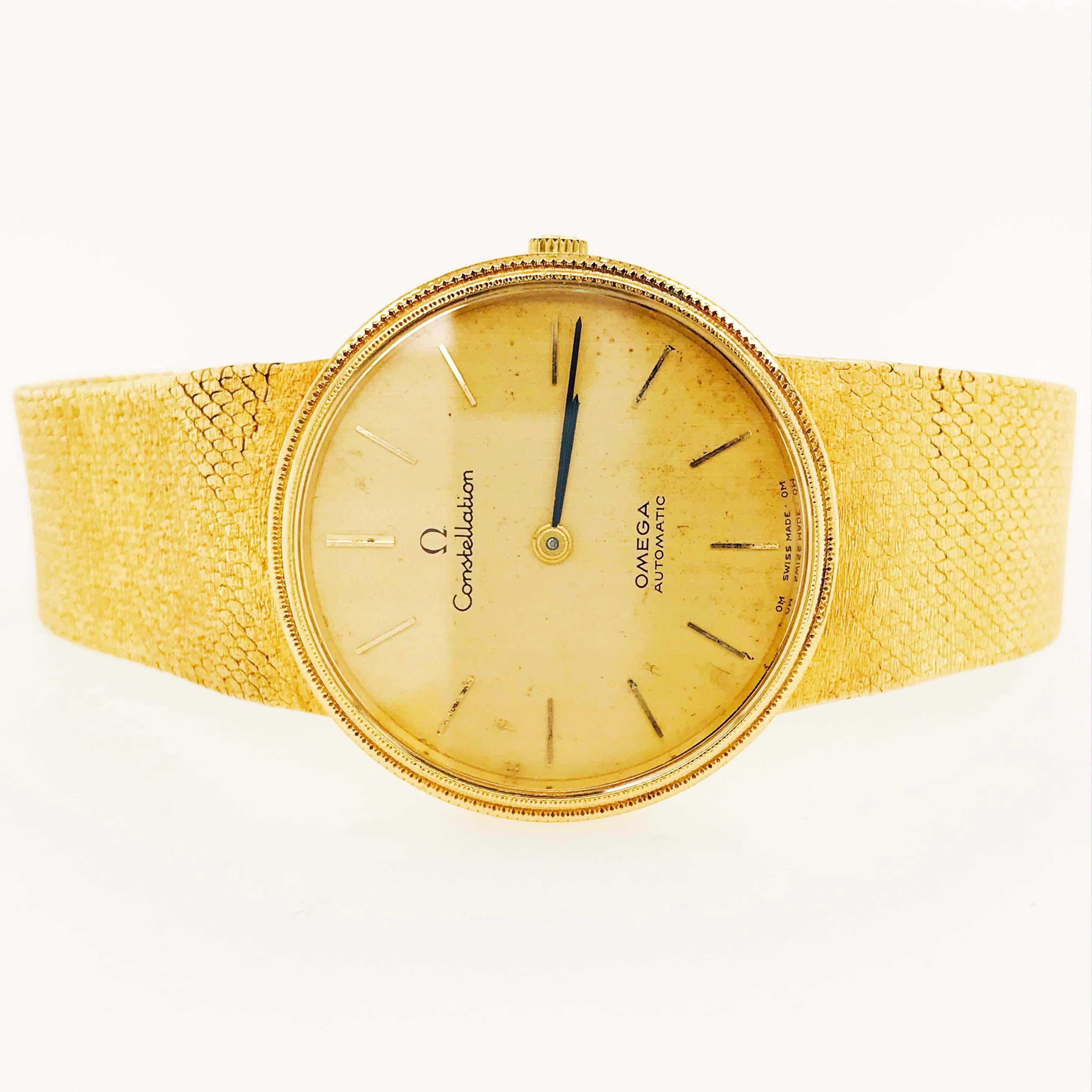 This genuine 18 karat yellow gold Omega Constellation watch is a timepiece that endures all ages!  Circa 1996 it has an 18 karat gold mesh band, clasp, case, dial, and face.  The round shape looks great on a medium to large size man's or woman's