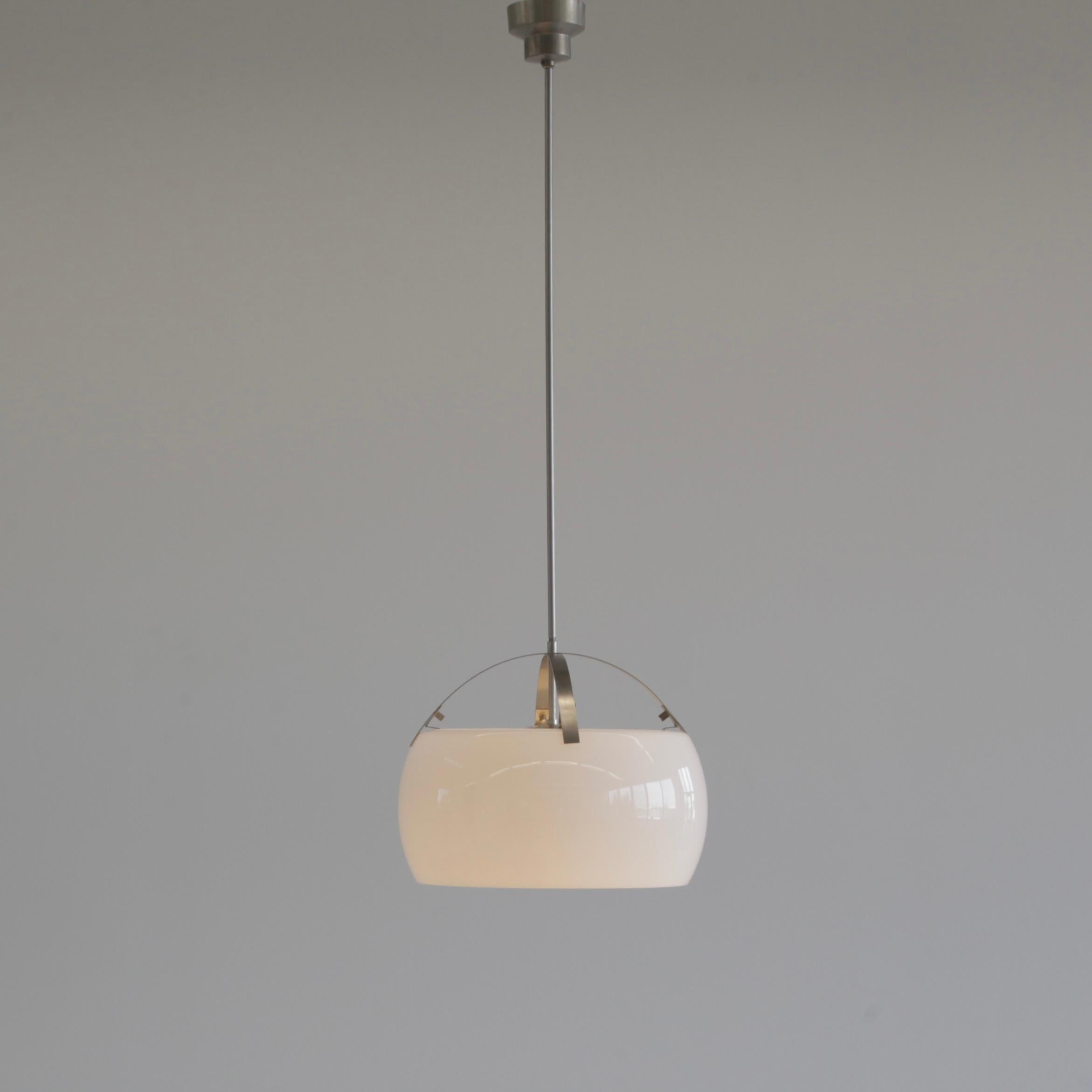 Hanging lamp designed by Vico Magistretti. Italy, Artemide, 1962.

The Omega lamp comprising of two separate pieces of opaline glass on a brushed metal frame.

We also have the XL size version (50 cm) available

Literature: Artemide catalogue