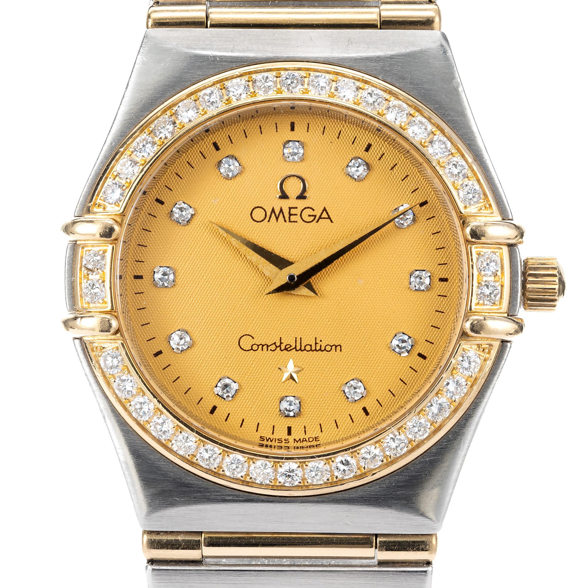 Ladies steel and 18k yellow gold Omega full bar  wristwatch. This watch features a, 12 round diamond dial accented by 36 diamond diamond bezel. 

36 round cut bezel set diamonds
12 round diamonds 
Length: 28mm
Width: 25mm
Band width at case:
