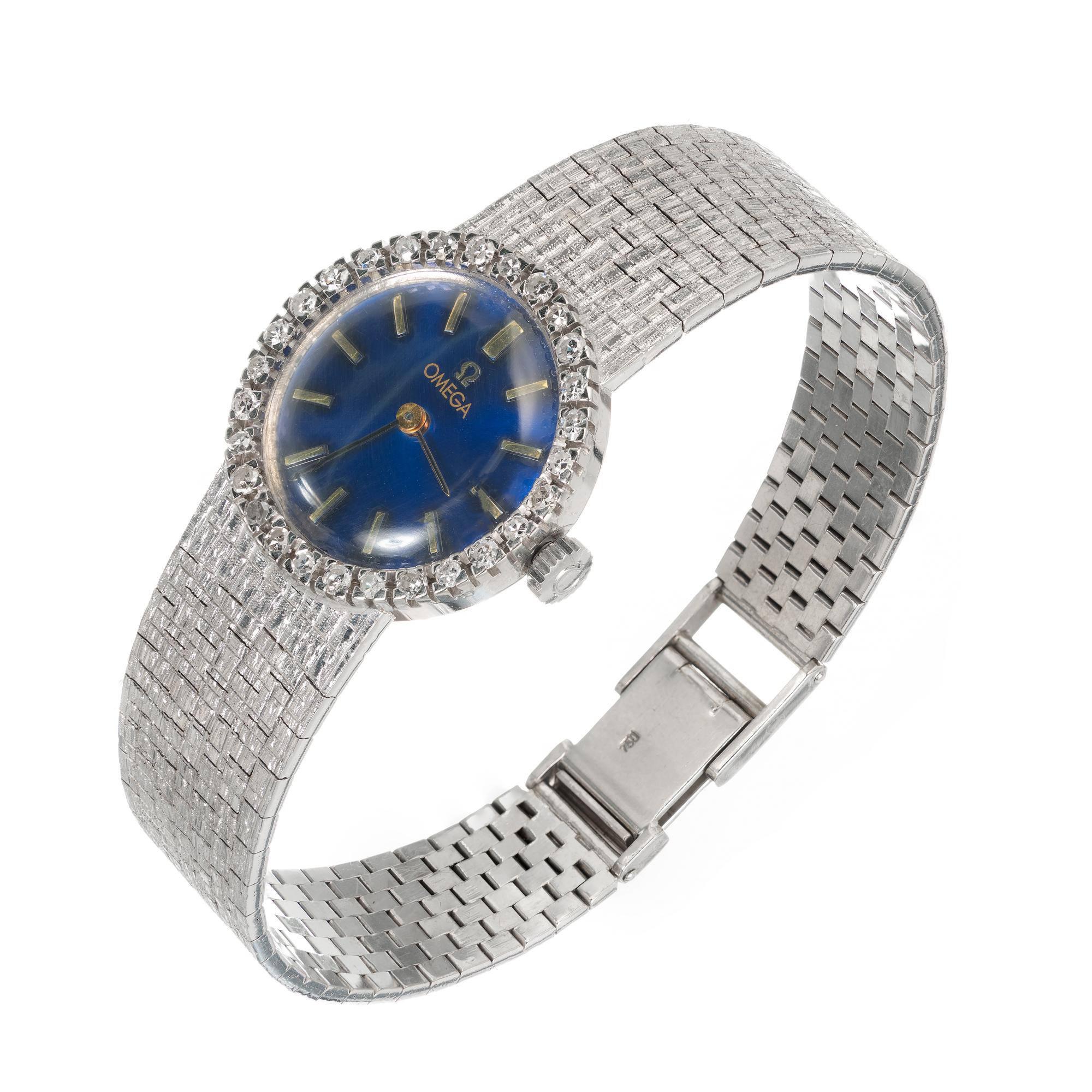 Vintage 1960's ladies Omega wristwatch in 18k white gold with diamond bezel and mesh textured band. Refinished royal blue Omega dial. 17 Jewel 620 Omega manual wind 17 jewel movement 

28 single cut diamonds 1.2-1.5mm approx total weight: .35cts 