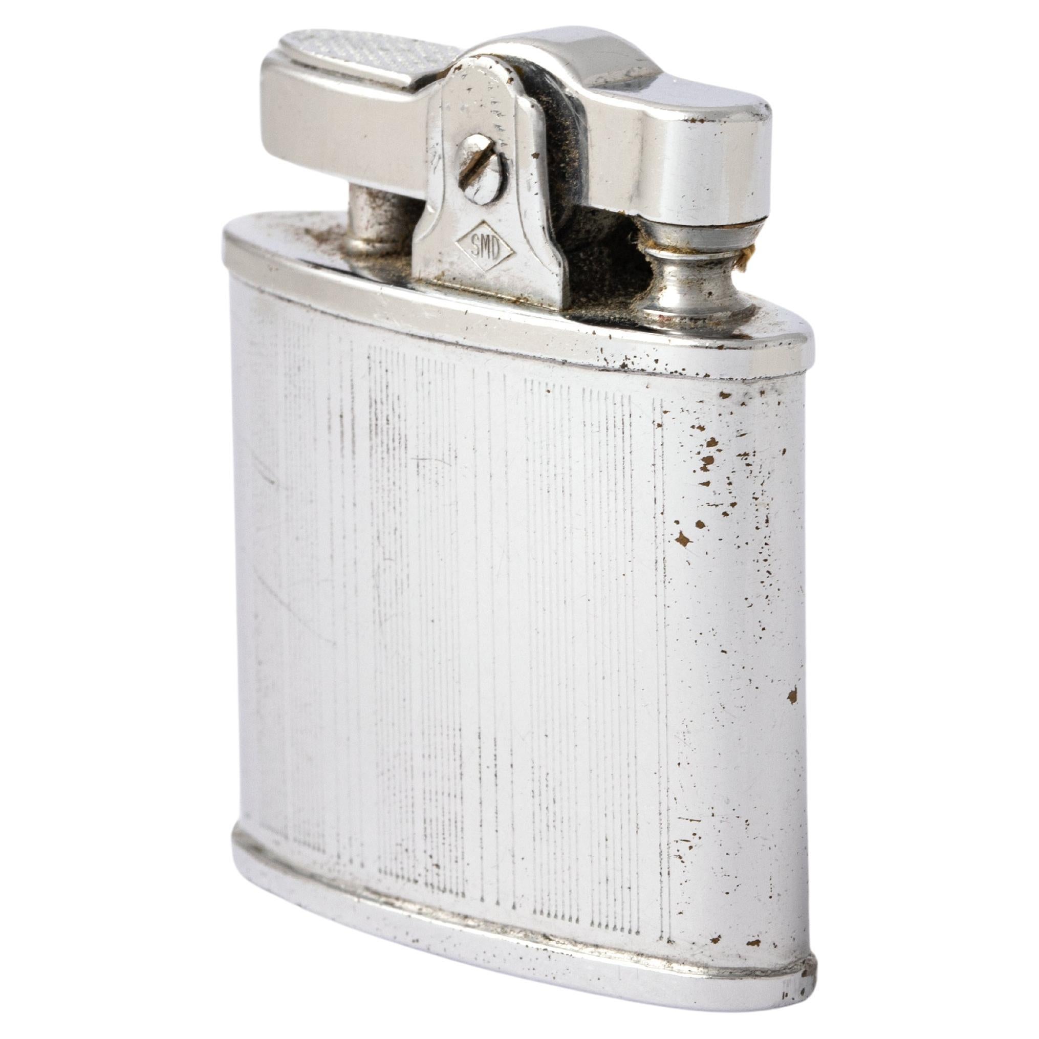 Omega Lighter. 
Circa 1950.
Total weight: 36.58 grams.
Height: 4.80 centimeters.
Width: 3.90 centimeters.
Depth: 1.40 centimeters.
Some traces of oxidation.
Item is not guaranteed to work.
