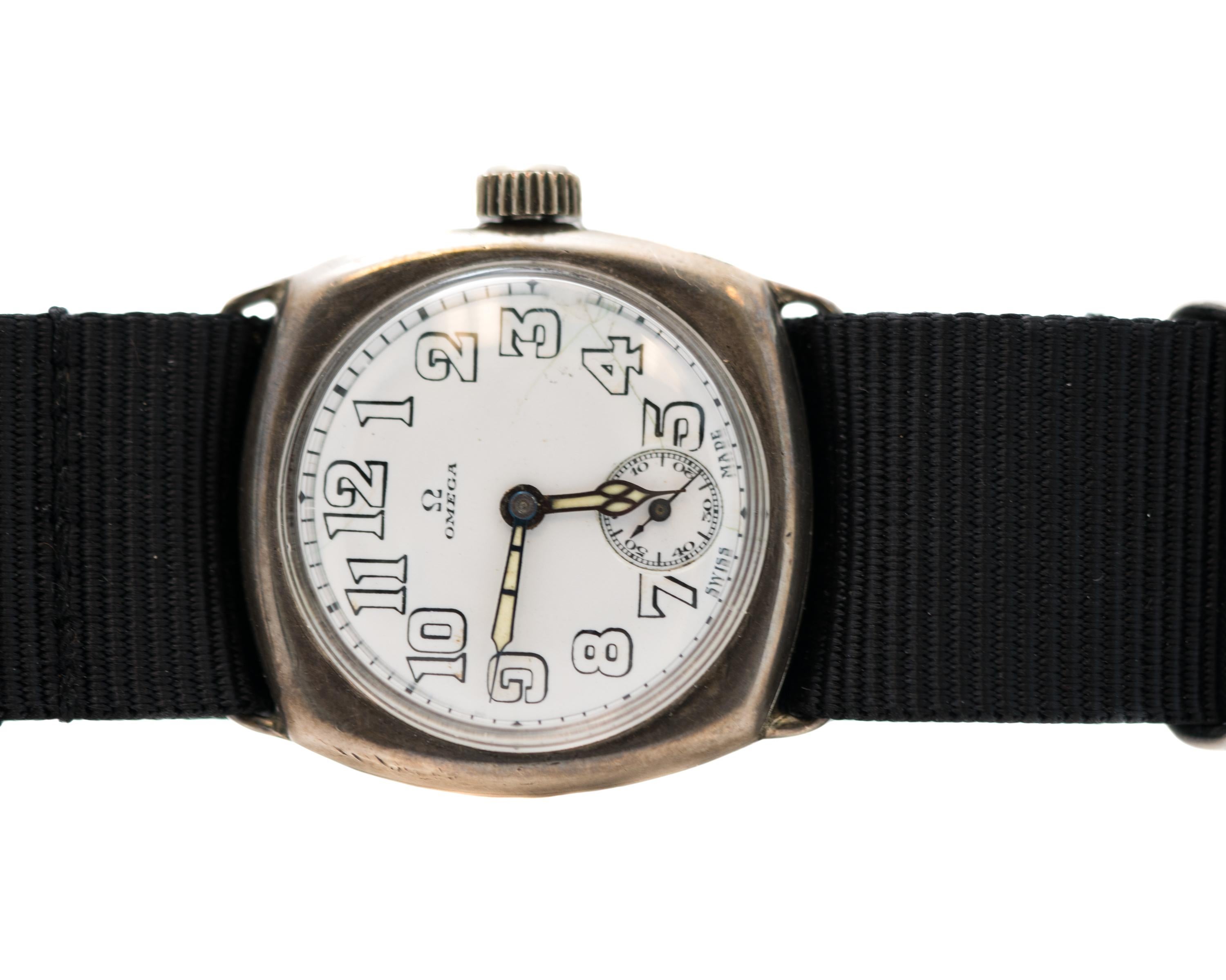 1920s Omega Military Watch with NATO Strap

Features: 
Case Diameter: 30 millimeter without crown, 33 millimeter with crown
Black NATO Strap fits up to 10.5 inch wrist, adjustable with buckle clasp
Seconds Subdial at 6:00 position
Black and White