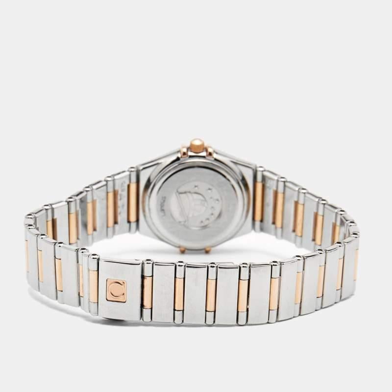 Grace your wrist with this elegant Omega Constellation wristwatch and make a statement. The watch pairs a mother-of-pearl dial featuring raised rose gold pyramid hour markers with a stainless steel & 18k rose gold round case and a diamond-studded