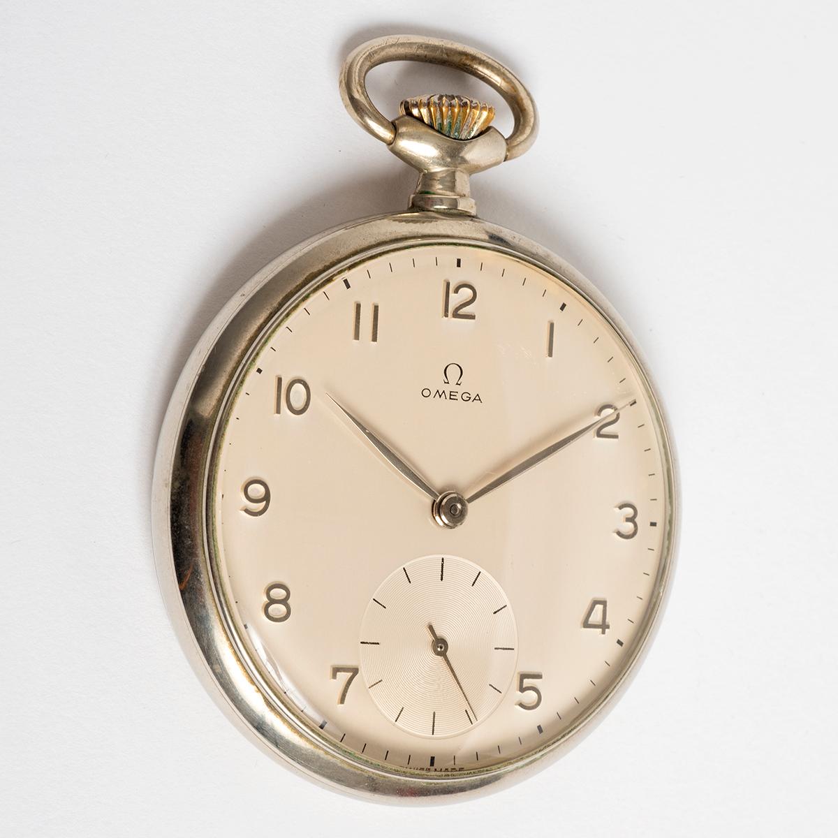 Our stunning vintage Omega pocket watch , reference 141-65, features a 48mm nickel/ chrome case (60mm incl crown and pendant), and wonderful matt silver dial with Arabic indices and textured sub seconds dial. Powered by a manually wound cal 161 15