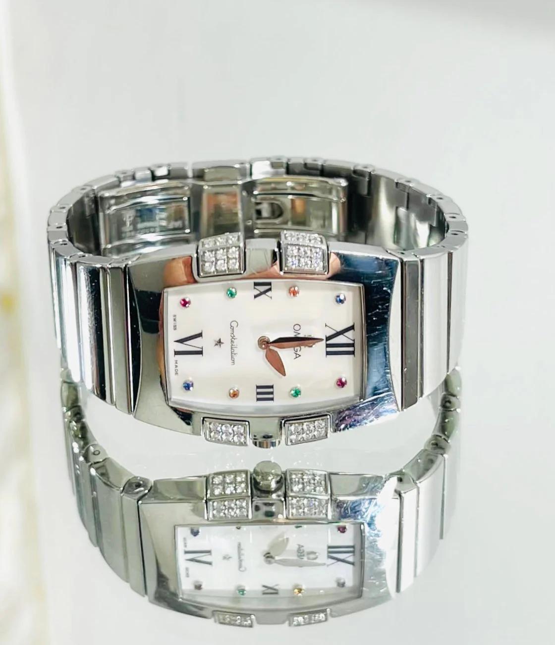 Omega Quadrella Constellation Mother Of Pearl & Diamond Watch

The Constellation Quadrella model accentuates its Constellation heritage with 48 brilliant white diamond claws. Roman numerals to the white mother of pearl face and having 2 rubies, 2