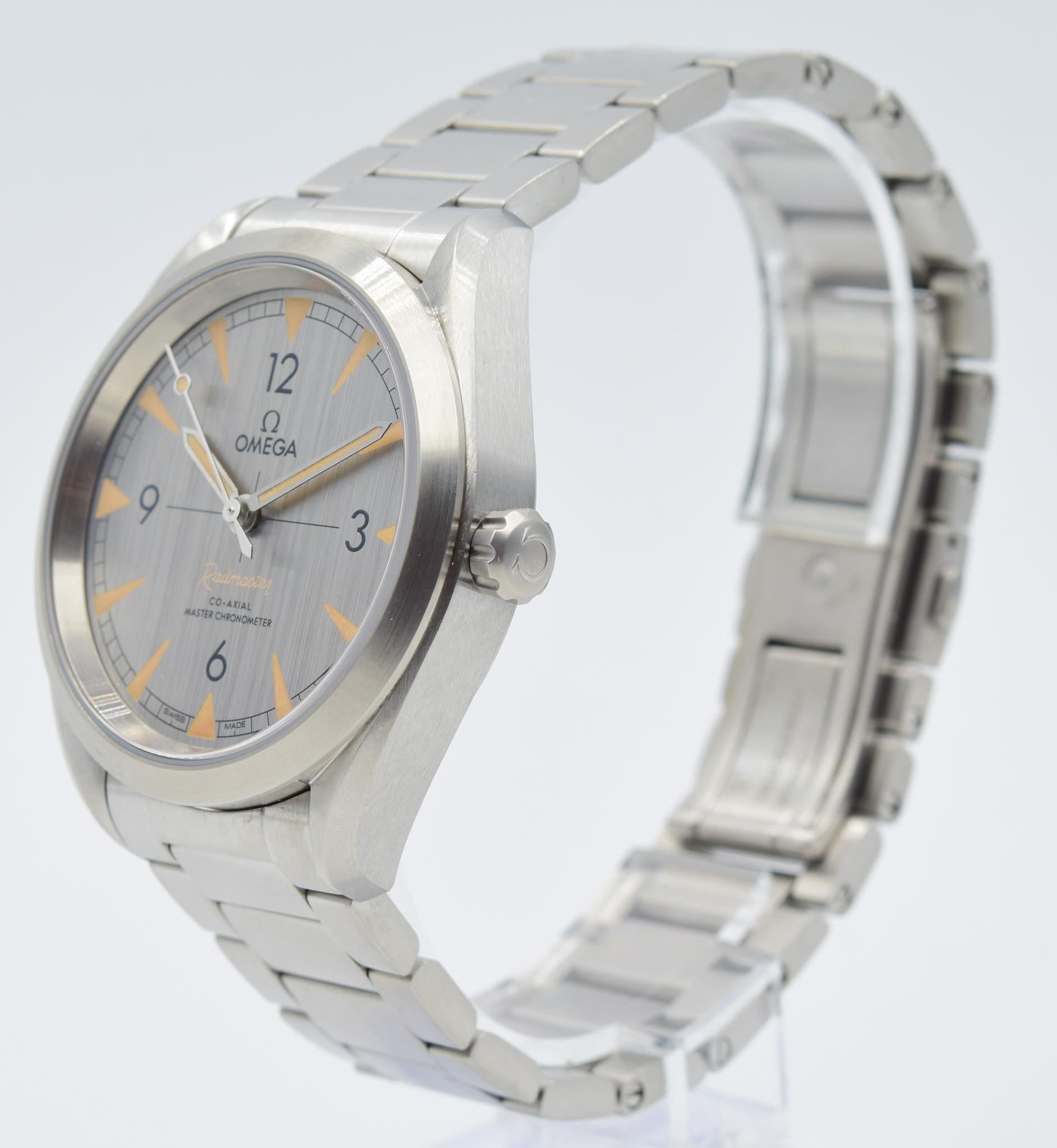 This Omega Railmaster was recently traded in to our store and is in very good condition! This watch comes with the full box and papers! This model comes in a 40mm stainless steel case on a bracelet. This watch features a silver dial with faux-patina