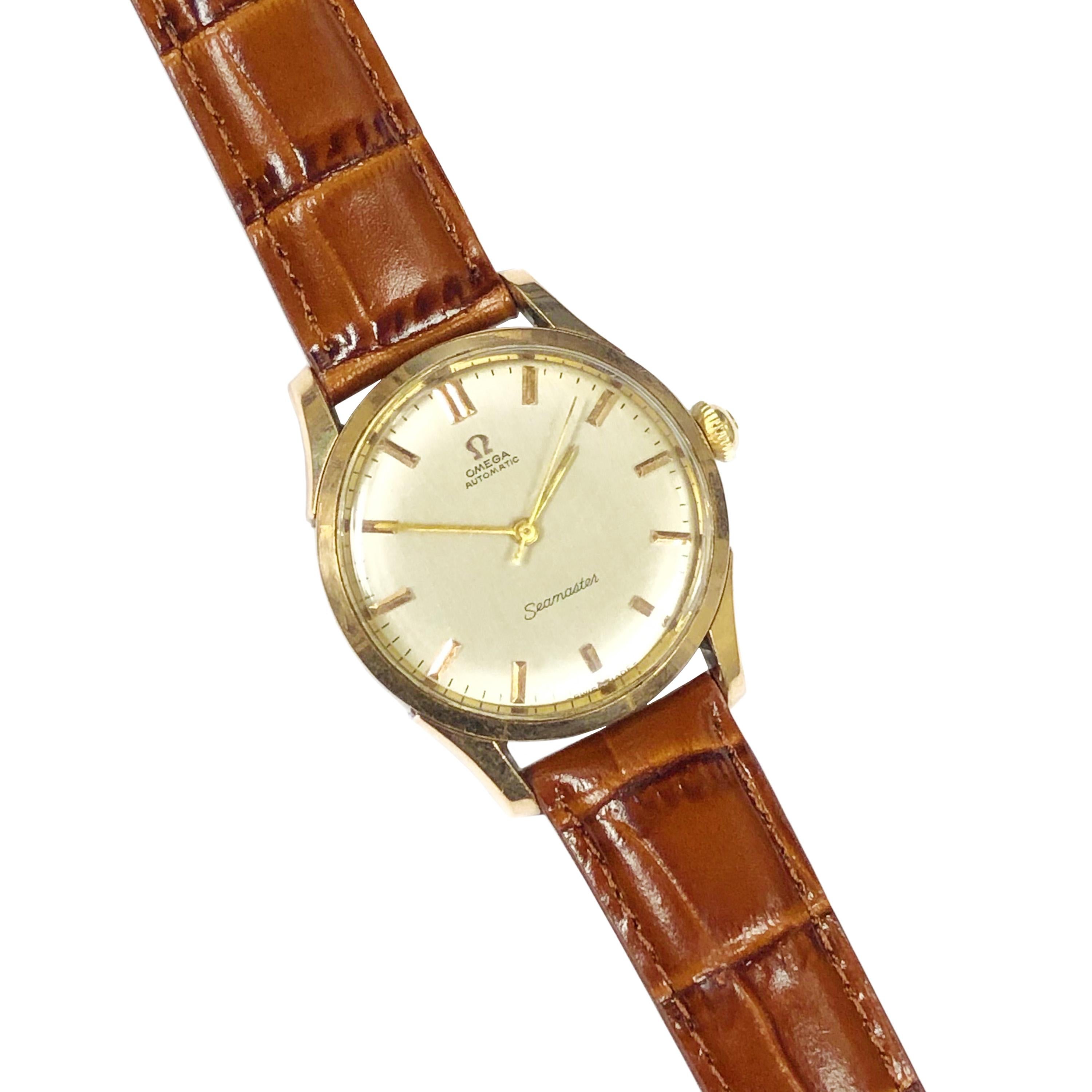 Circa 1960 Omega Seamaster Wrist Watch, 35 MM Water Proof 2 Piece Stainless Steel Case with Yellow Gold Bezel and Gold Lug Tops. Caliber 501 Automatic, self winding movement. Original Mint condition Silvered Dial with Raised Gold Markers, Gold hands