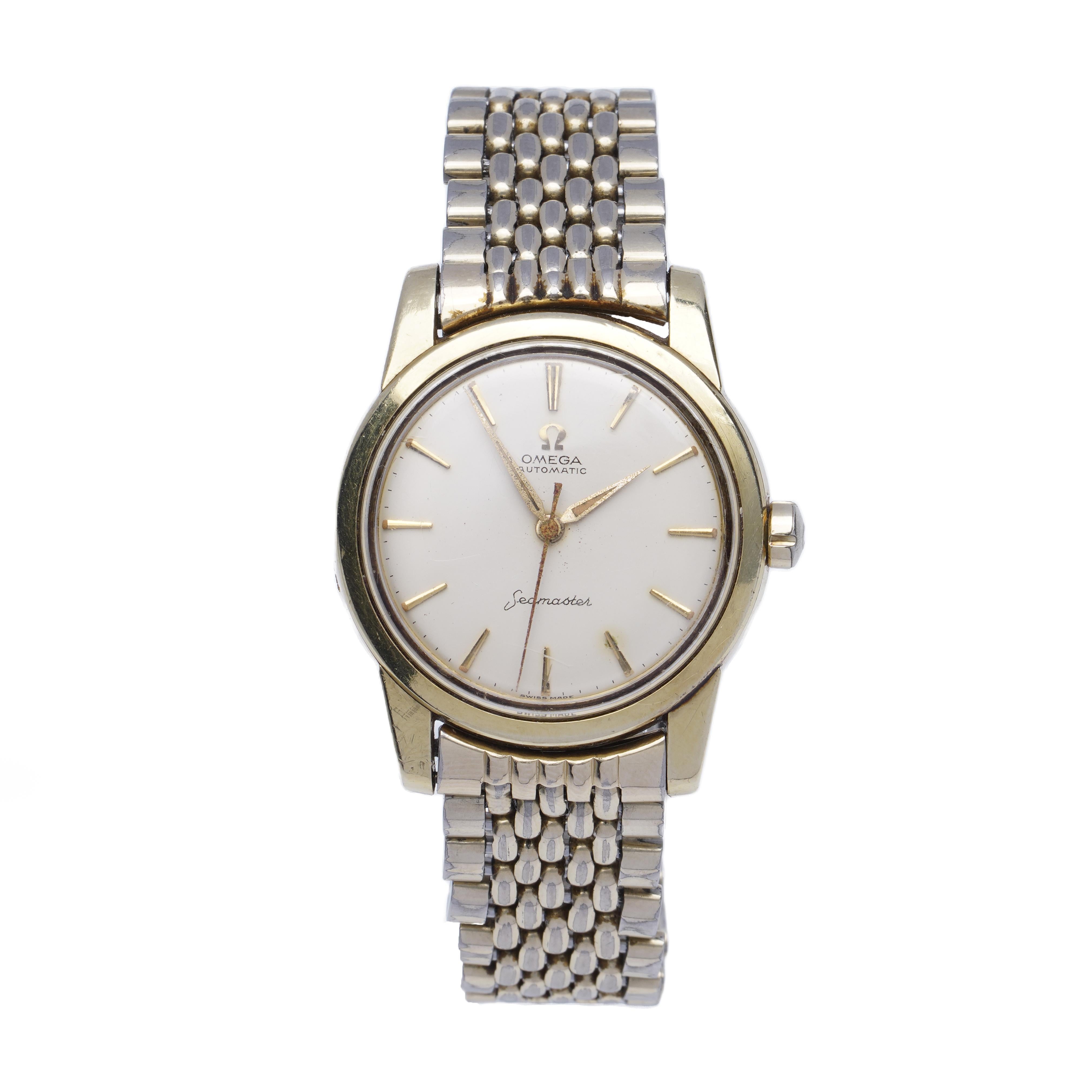 Omega Seamaster Automatic men's wristwatch, 1960's 

Case Diameter: 34 mm
Movement: Mechanical Automatic 
Case Material: Gold-plated 
Watchband Material: Stainless steel 
Dial colour: Cream coloured with golden indices 
Display Type: Analogue
Glass: