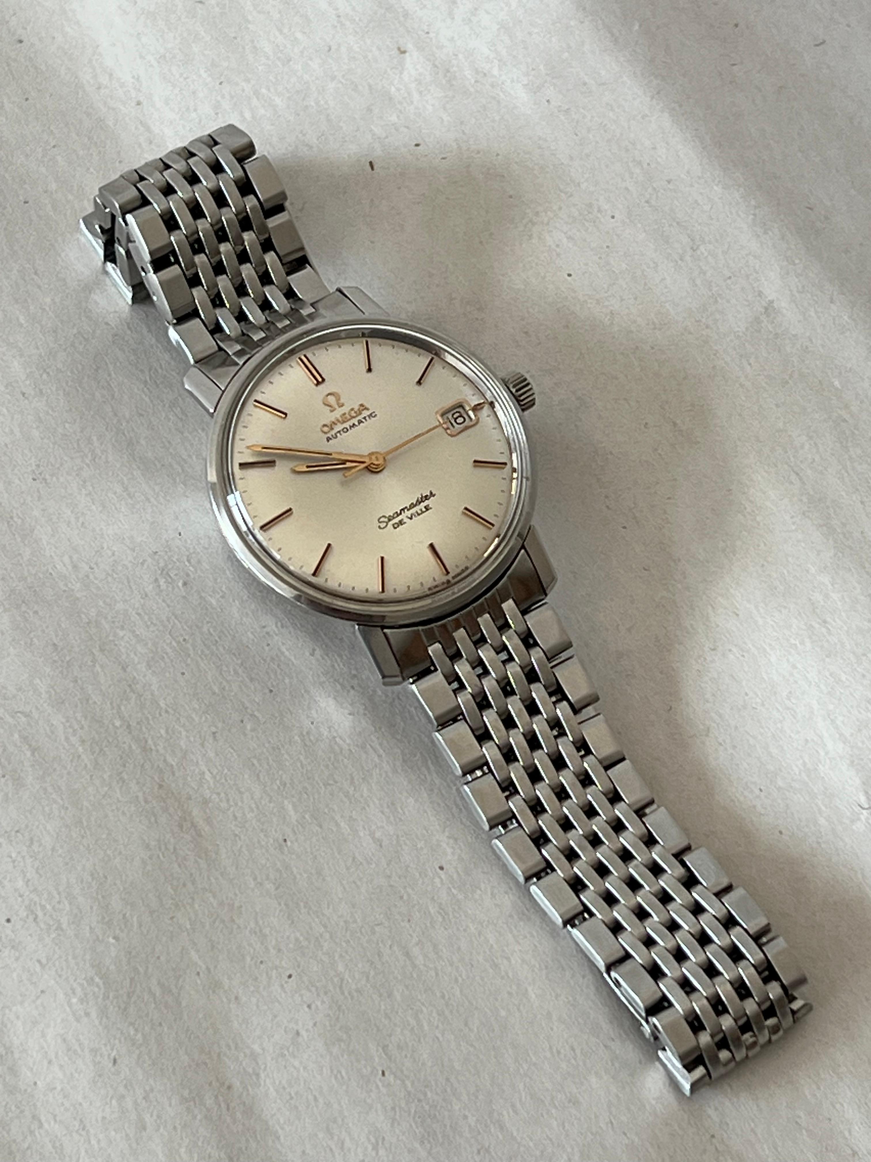 Here is a classic Omega Seamaster Deville with a date. Stainless steel with original bracelet, this watch is very clean and keeping really good time (under 10 seconds per day).  Lovely dial has developed a light cream tone, sunburst brushed patter