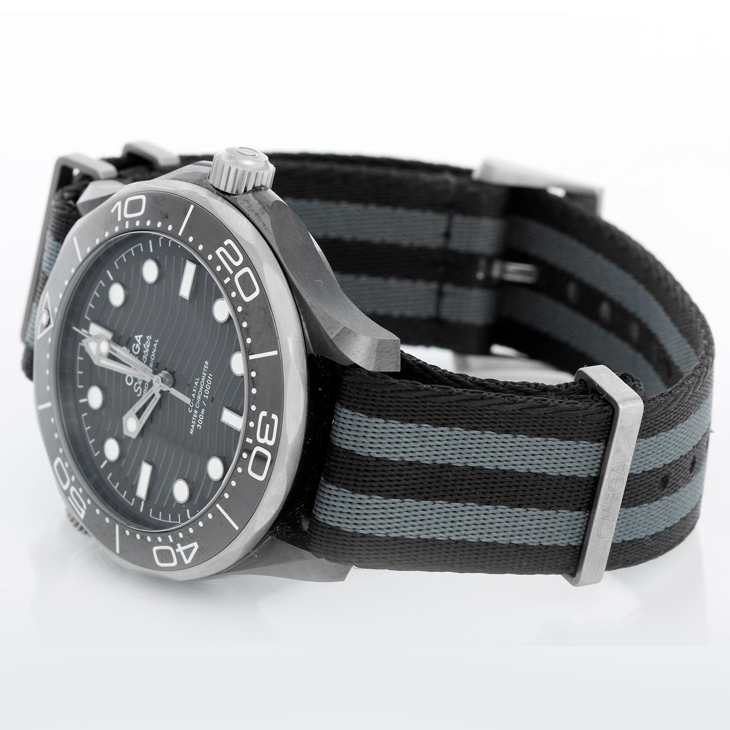 Omega Seamaster Diver 300 M Co-Axial Master Chronometer 210.92.44.20.01.002 - Automatic winding. Black Ceramic with Grade 5 Titanium Case (43mm). Black wave dial with luminous markers. Black & Grey 5-stripe Nato Strap with Omega titanium buckle.