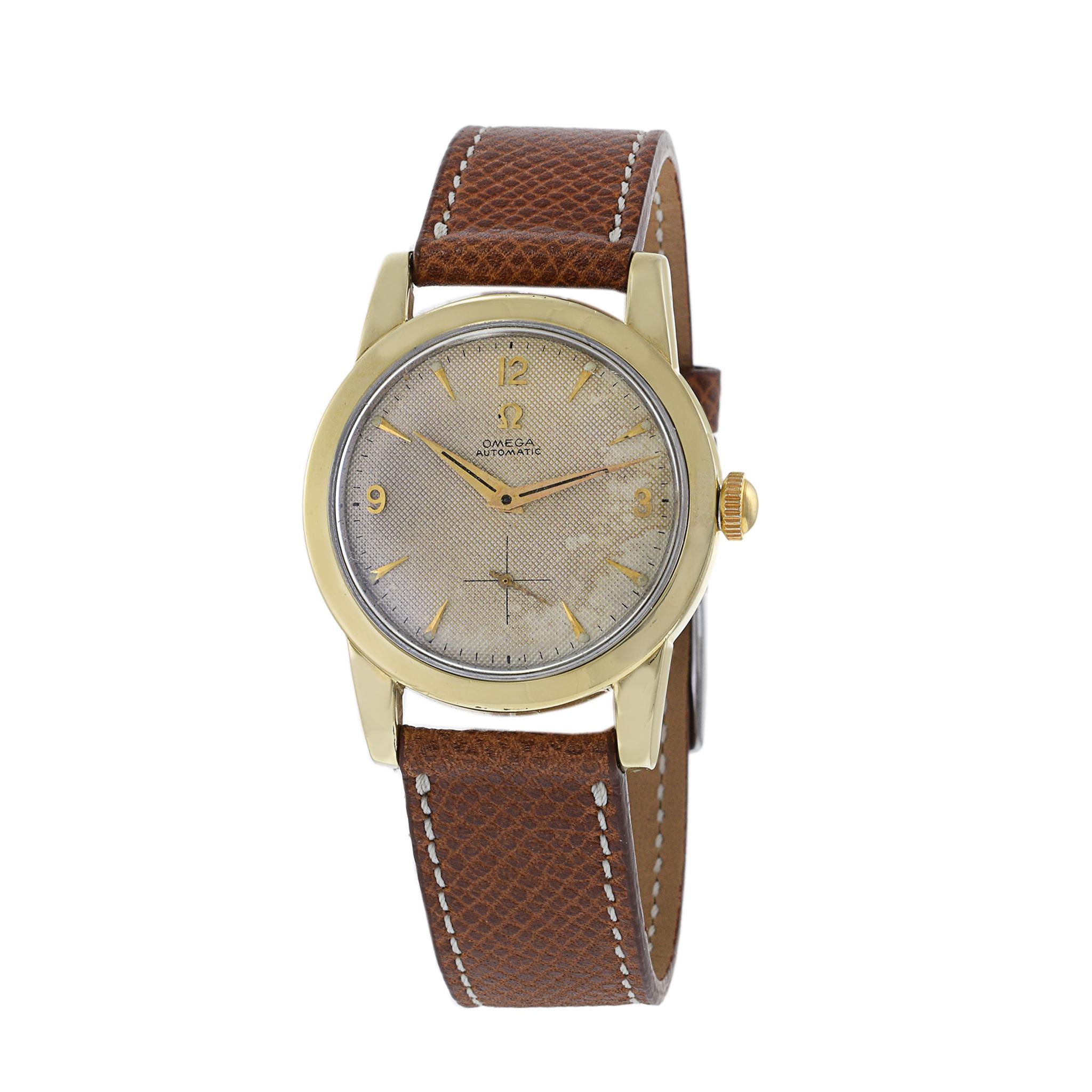 This is a nice condition 1954 Omega Seamaster with honeycomb dial. The bezel is solid 14K yellow gold and the lugs are gold top. The case is 34mm in diamter and appears unpolished. The dial has applied gold hour indices and gold hands.

The watch is