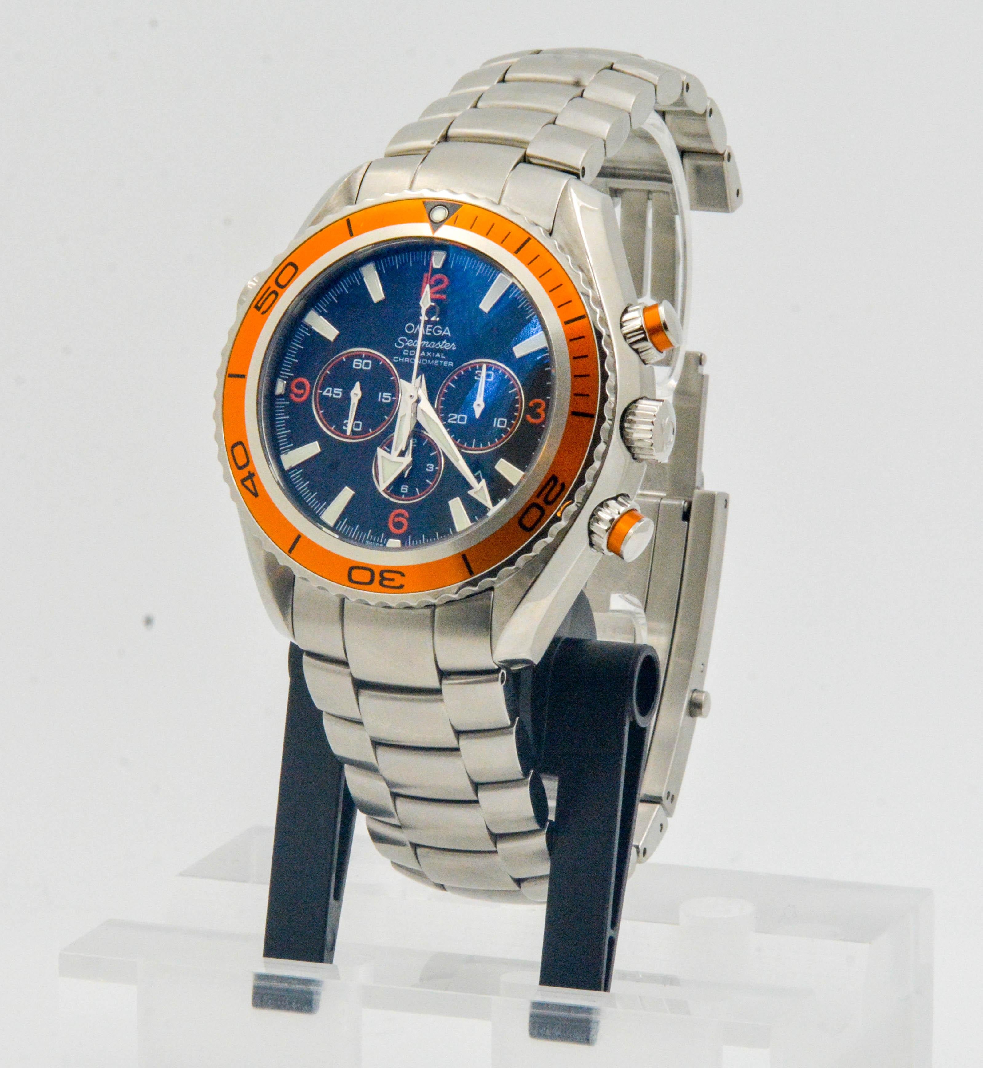 • Model: OMEGA Seamaster Planet Ocean Chronograph
• Movement: Automatic, water resistant diver's watch
• Case Size: 45mm 
• Case Material: Stainless steel
• Dial: Dark Navy Blue with orange bezel; with 3 sub dials 
• Strap: Stainless steel