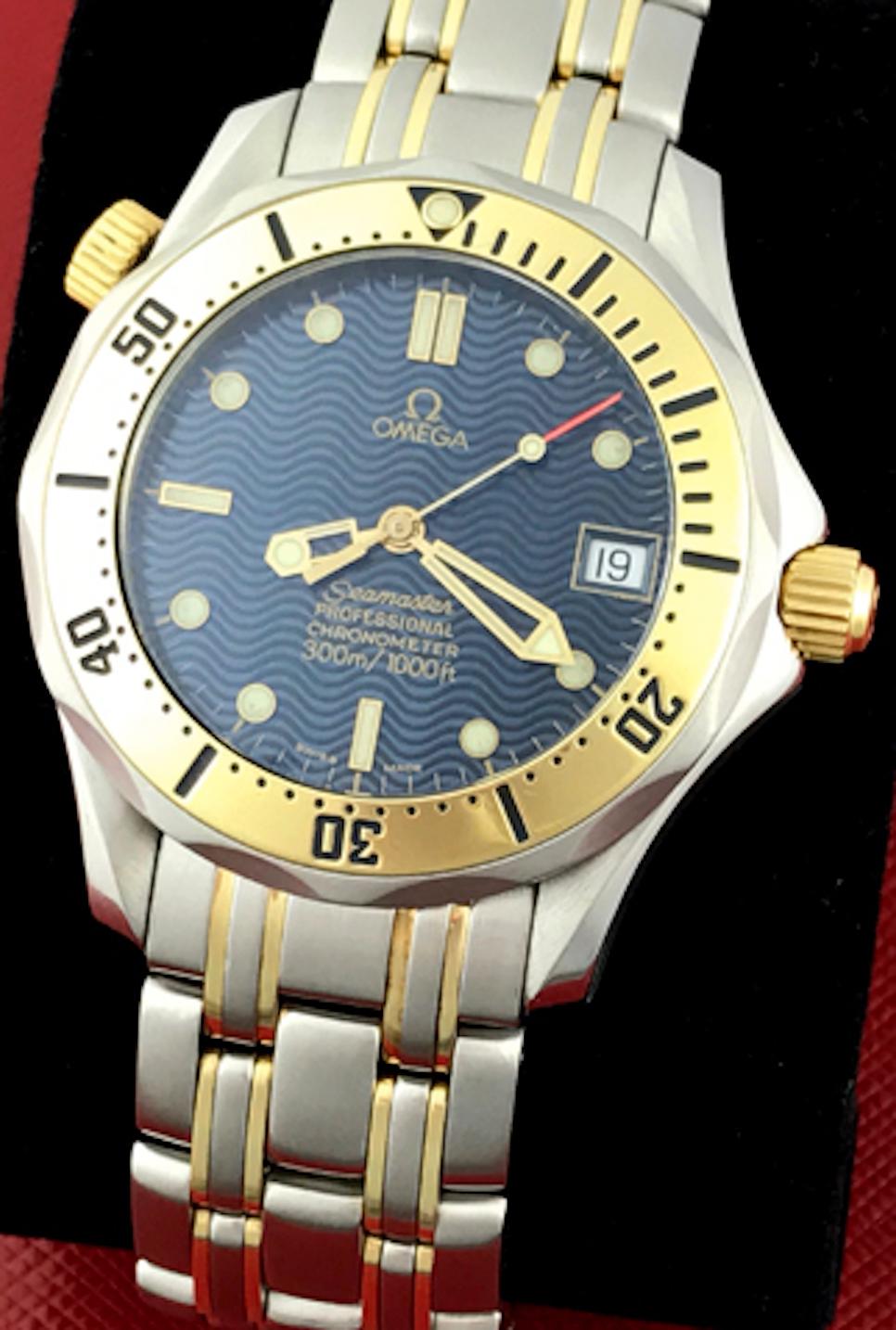 Omega Mens Seamaster Professional Automatic with Date and with Helium Release Valve. Stainless Steel round style case with 18k Yellow Gold bezel (35mm dia.) Stainless Steel and 18k Yellow Gold Gold bracelet with deployant clasp.  Blue wave Dial with