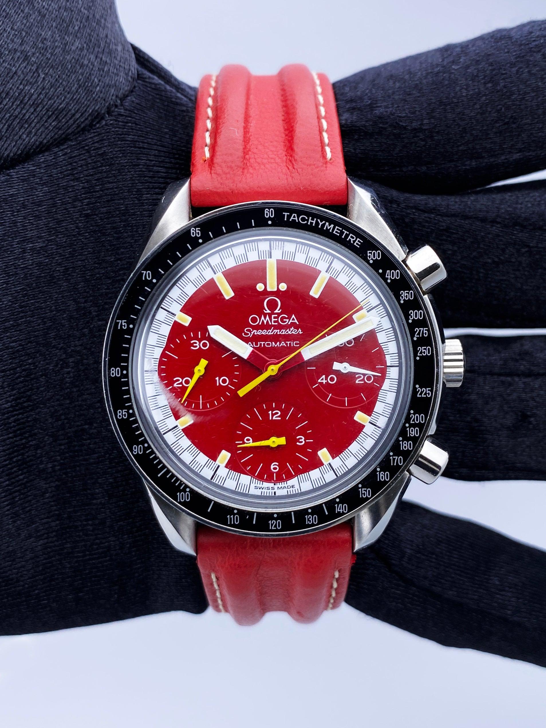Omega Speedmaster Michael Schumacher 3810.61.41 Mens Watch. 39mm stainless steel case. Stainless steel tachymeter bezel with black insert. Red dial with luminous hands and index hour markers. Three sub-dials. Small seconds hand at 3 o'clock.