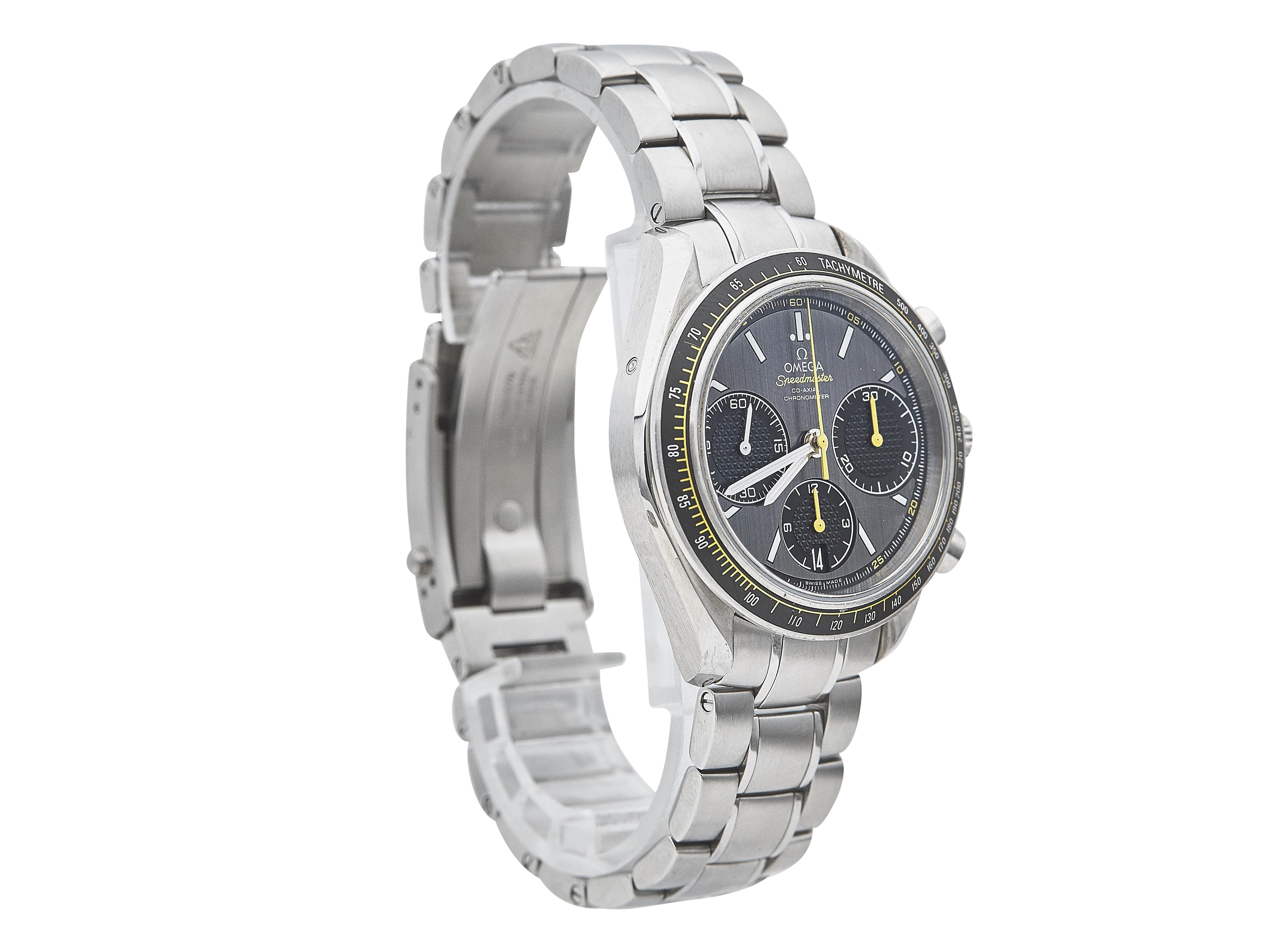 This Omega Speedmaster Racing is a stylish and sporty watch featuring a sleek grey dial housed in a stainless steel case. The watch is pre-owned, with noticeable scratches on the case, but the dial remains in excellent condition with no signs of