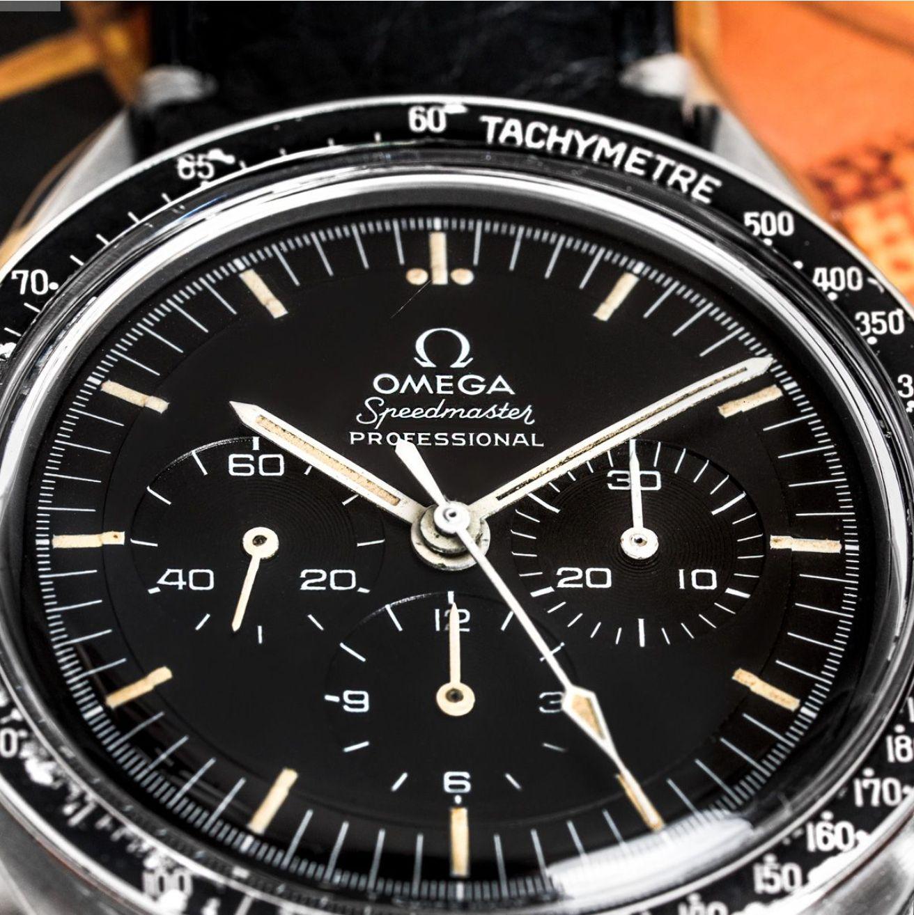 A stainless steel vintage Speedmaster Professional wristwatch by Omega. Featuring a black dial with 3 chronograph counters and a stainless steel fixed tachymetre bezel. Equipped with a generic black leather strap and an original steel deployant