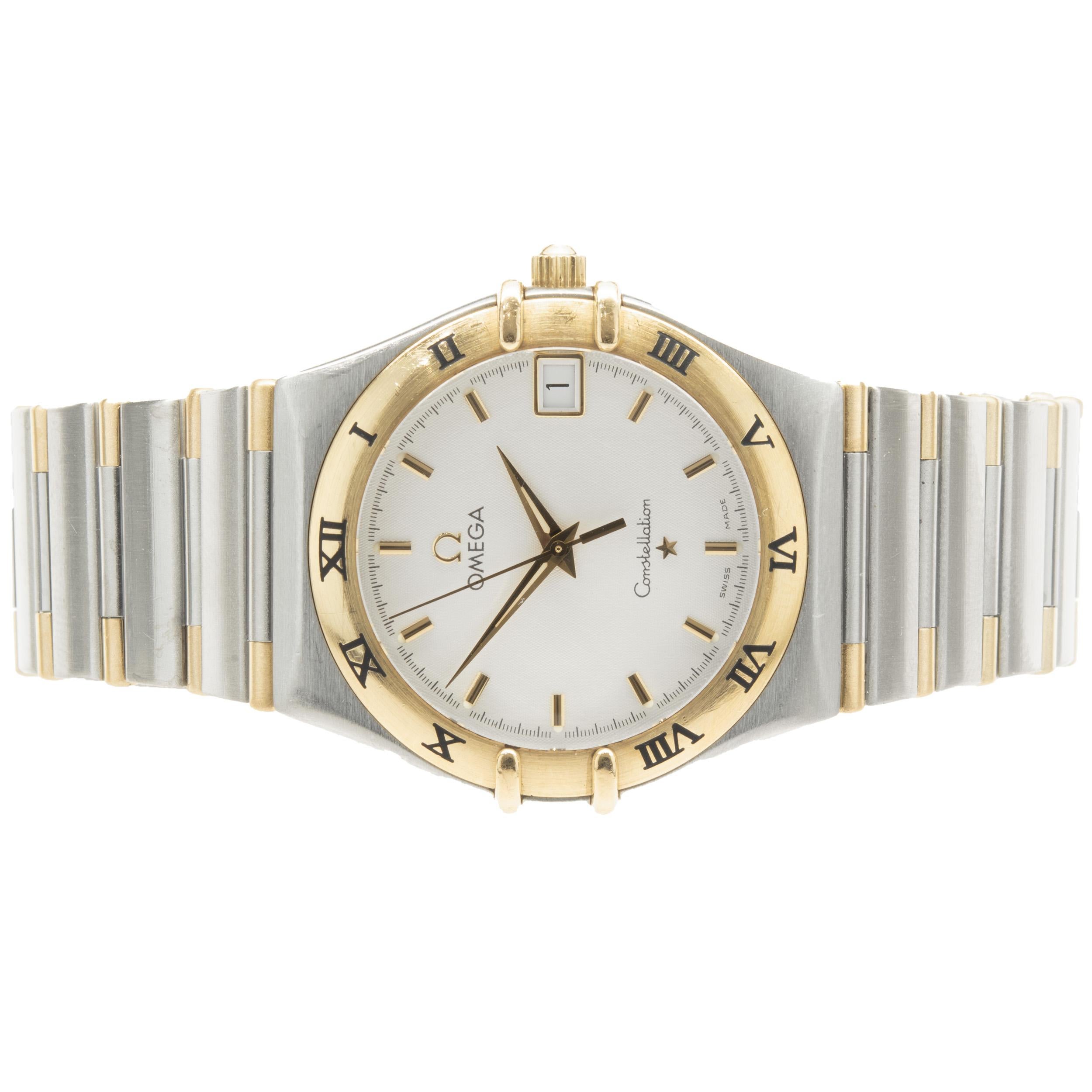 Brand: Omega
Movement: quartz
Function: hours, minutes, seconds, date
Case: 34mm stainless steel round case, 18K yellow gold roman numeral bezel
Band: Omega stainless steel & 18K yellow gold bracelet, deployment clasp
Dial: white stick 
Serial #