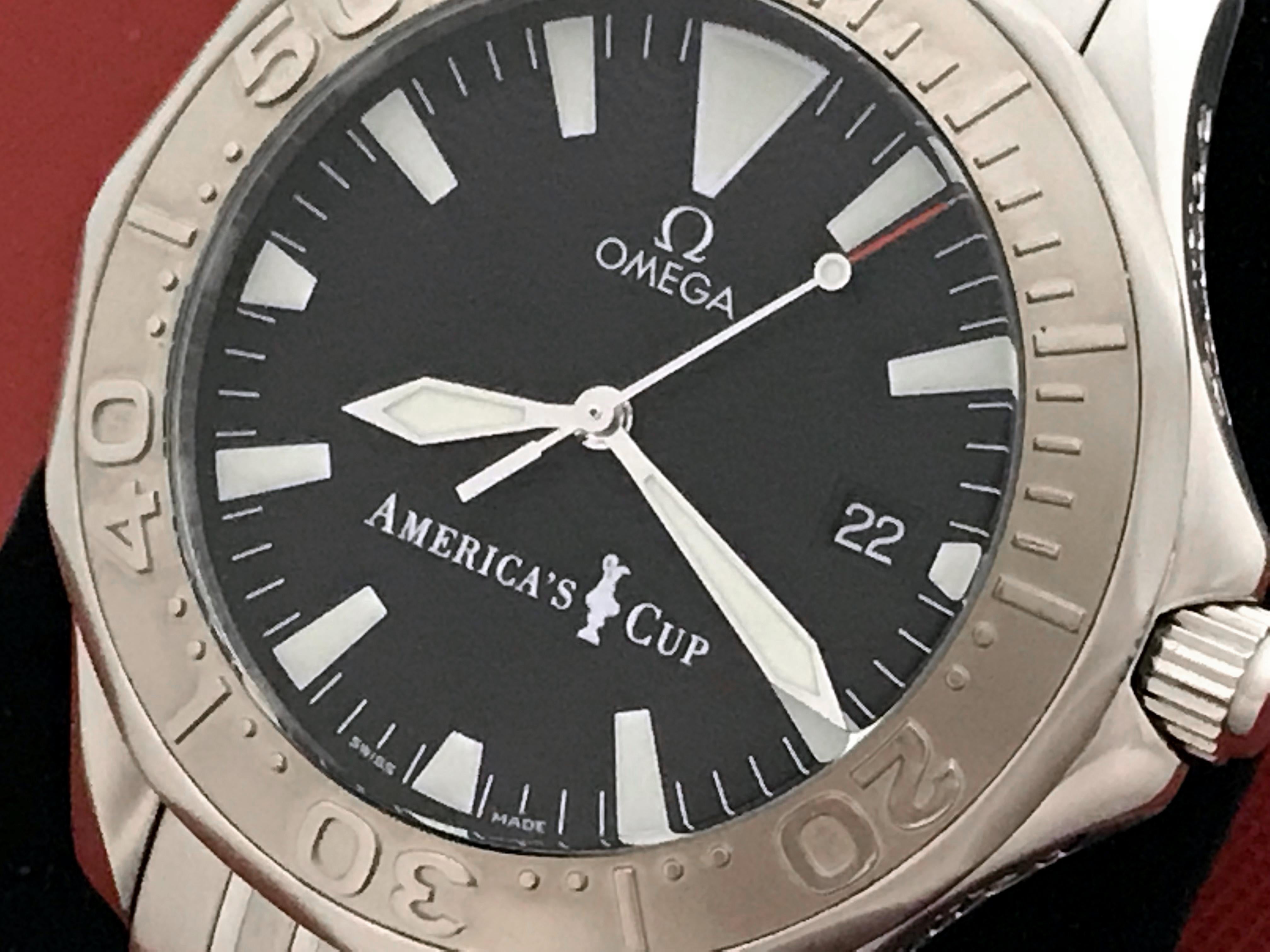 As New Omega Mens Seamaster Limited Edition America's Cup, Model 2533.50.00.  Stainless Steel round style case with rotating bezel and helium release valve. (40mm dia.). Stainless Steel Omega Seamaster bracelet with deployant clasp.  Black wave Dial