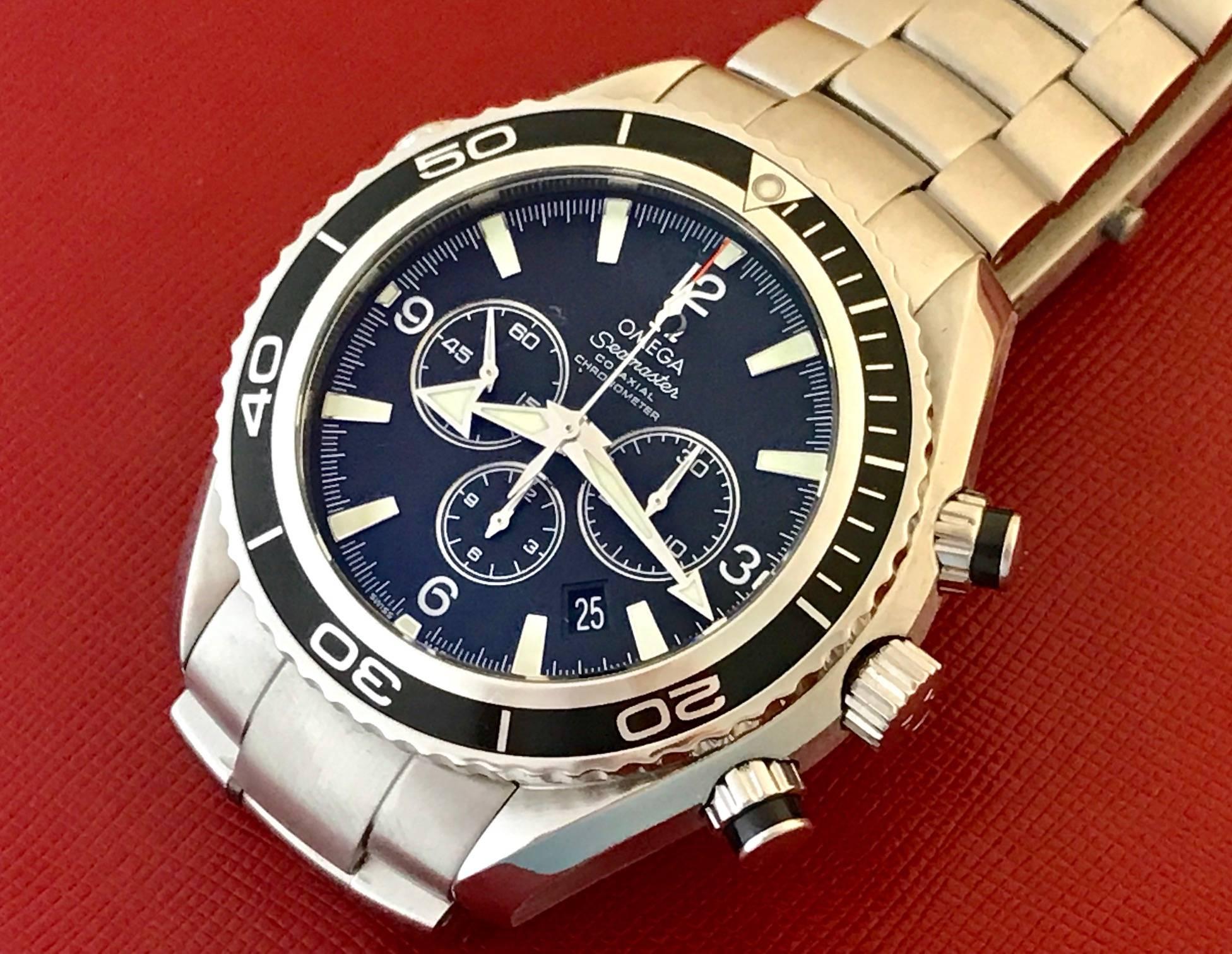 Omega Mens Seamaster Planet Ocean Chronograph. Automatic Winding Co-Axial Movement, Helium Release Valve. Stainless Steel round style case with black rotating bezel (42mm dia.). Stainless Steel Omega Seamaster bracelet.  Black Dial with luminous