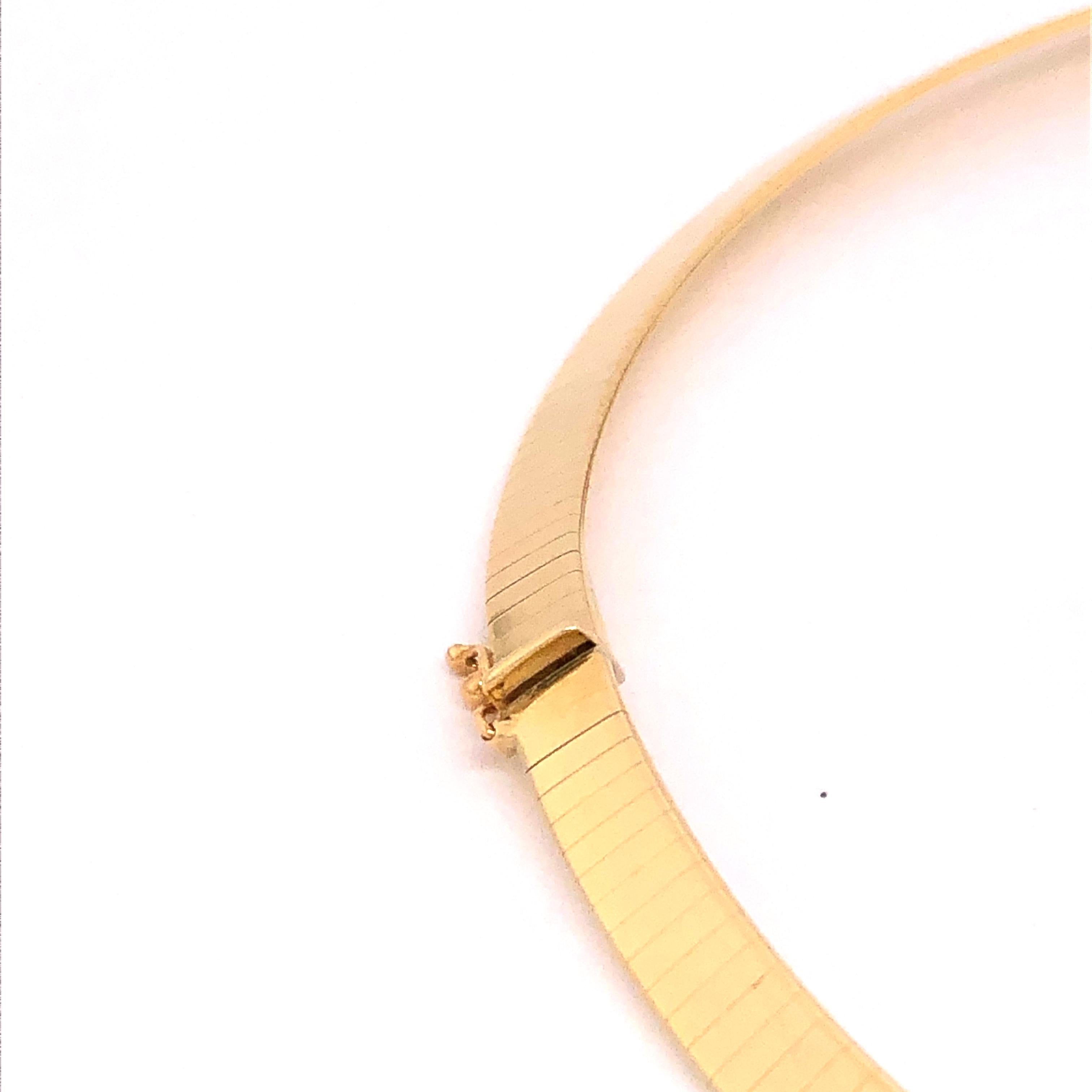 Elegantly bold this omega style 14K yellow gold necklace is well suited for casual and business occasions. It sits comfortably on your collar almost becoming a part of you. 

Stamped: Italy, 14Kt