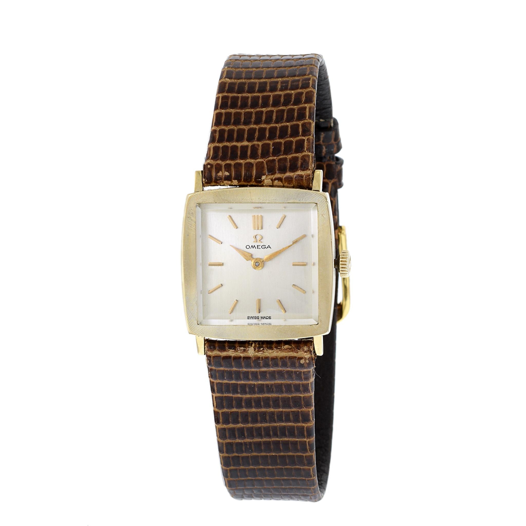 This is a Omega tank watch in 14K yellow gold. This watch is a reference 6696. The watch is powered by a 17 jewel manual wind caliber 620 movement. This watch has a silver dial with baton markers and its original crown. It is triple signed on the