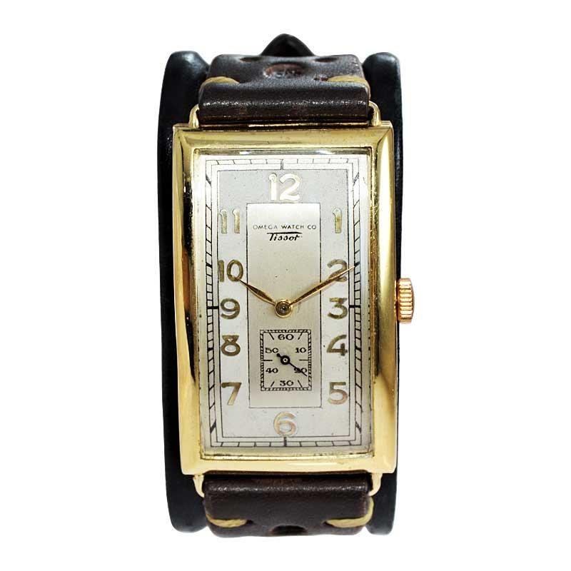 FACTORY / HOUSE: Omega / Tissot
STYLE / REFERENCE: Oversized Wrist Watch
METAL / MATERIAL: Yellow Gold Filled
CIRCA / YEAR: 1930's
DIMENSIONS / SIZE: Length 53mm X Width 29mm
MOVEMENT / CALIBER: Manual Winding / 17 Jewels 
DIAL / HANDS: Original Two