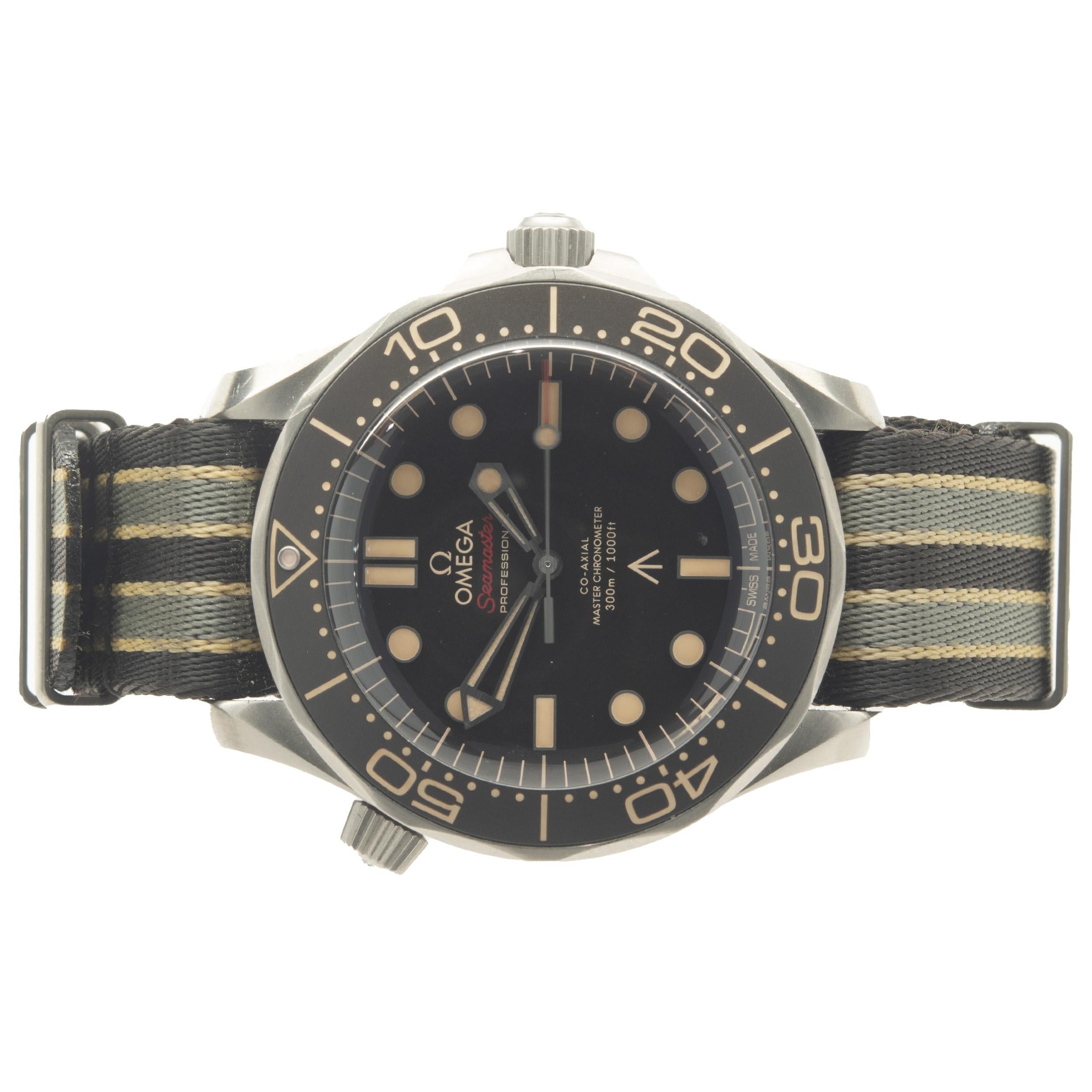 Brand: Omega
Movement: automatic
Function: hours, minutes, seconds, timing bezel
Case: 42mm titanium round case, uni-directionally rotating timing bezel, push/pull crown
Band: nato strap, buckle clasp
Dial: brown dot 
Reference #