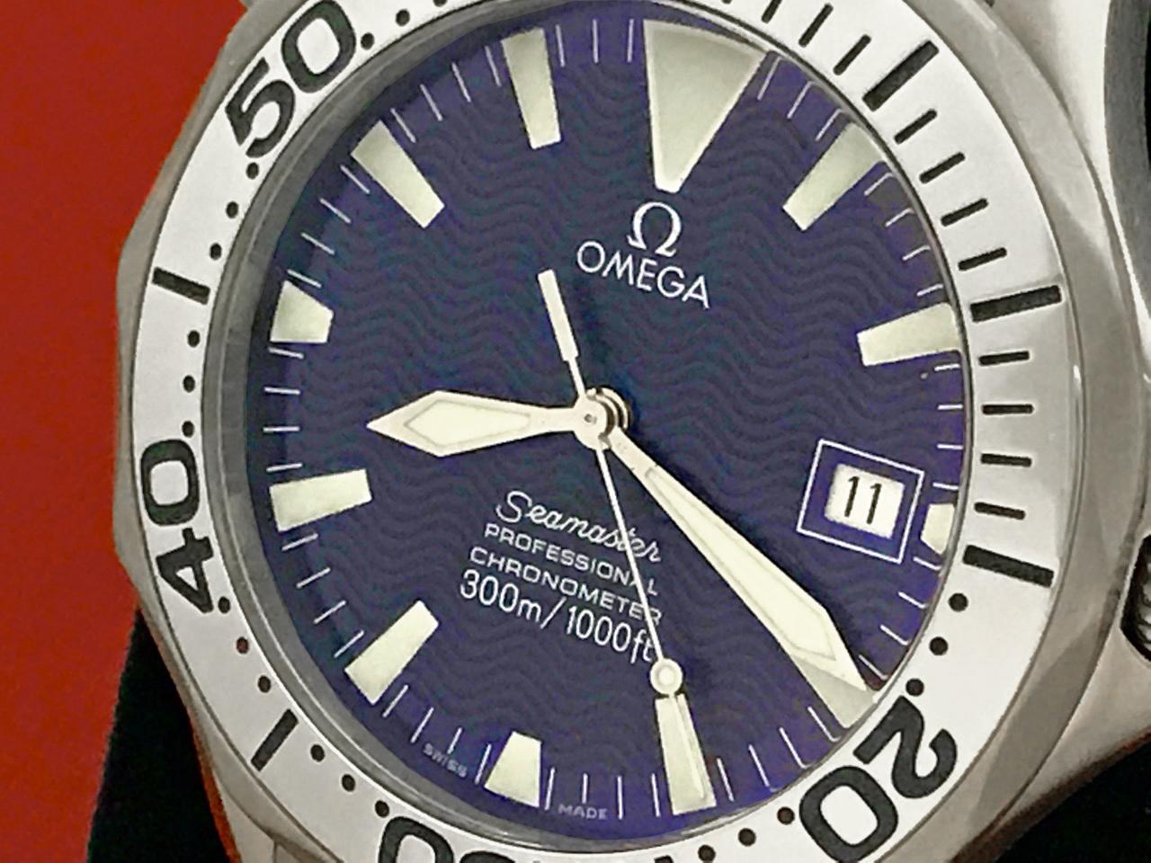 As New Omega Mens Seamaster Professional, Model 2231.80.  Titanium round style case with helium release valve and rotating bezel (41mm dia.). Titanium Omega Seamaster bracelet.  Blue wave Dial with luminous hour markers. Certified Pre Owned and