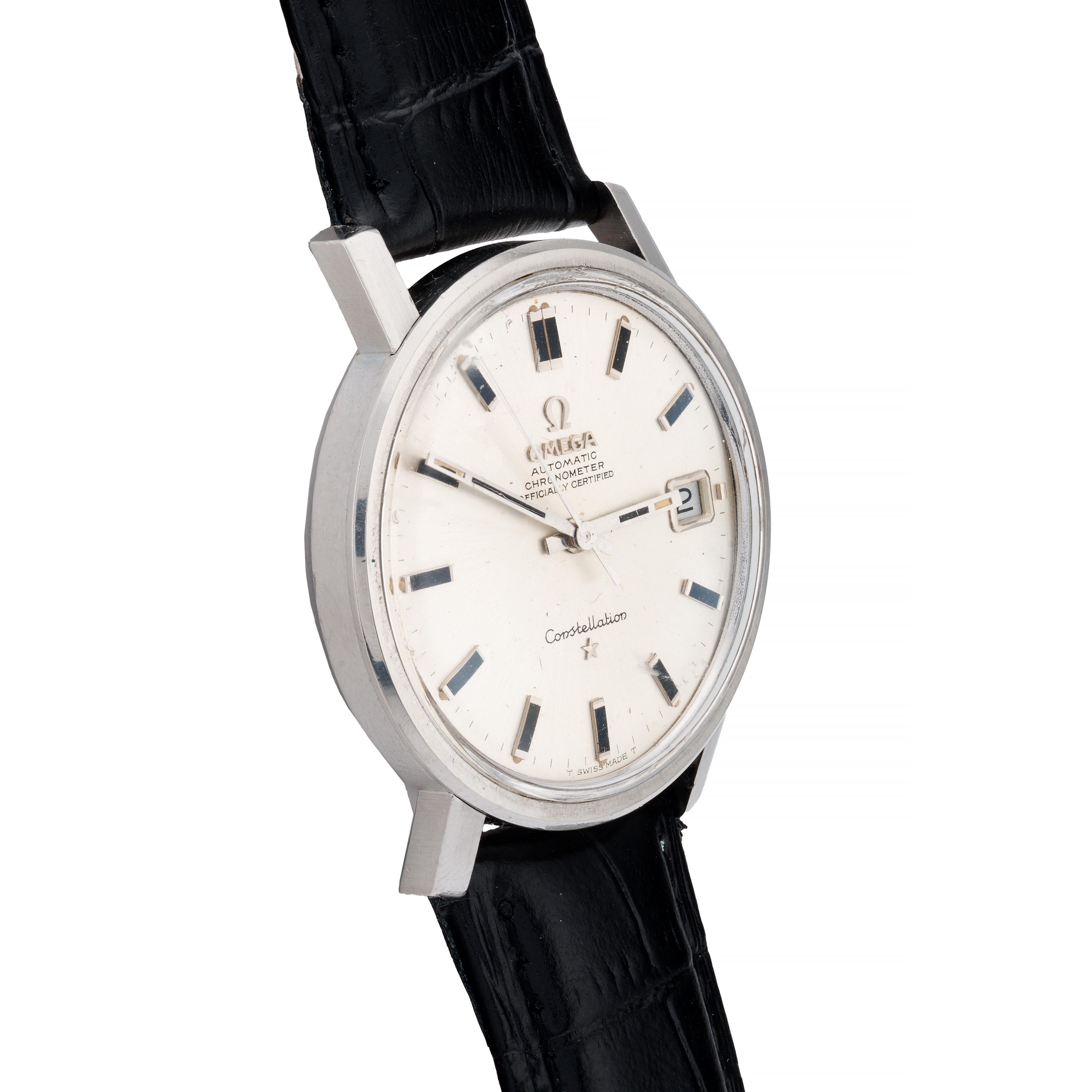 Aston Estate Jewelry Presents:

A vintage Omega Constellation wristwatch crafted in stainless steel.

The round watch features a clean, silver dial with bold black onyx inlaid baton hour markers and a date window at 3 o'clock. The Omega signature is