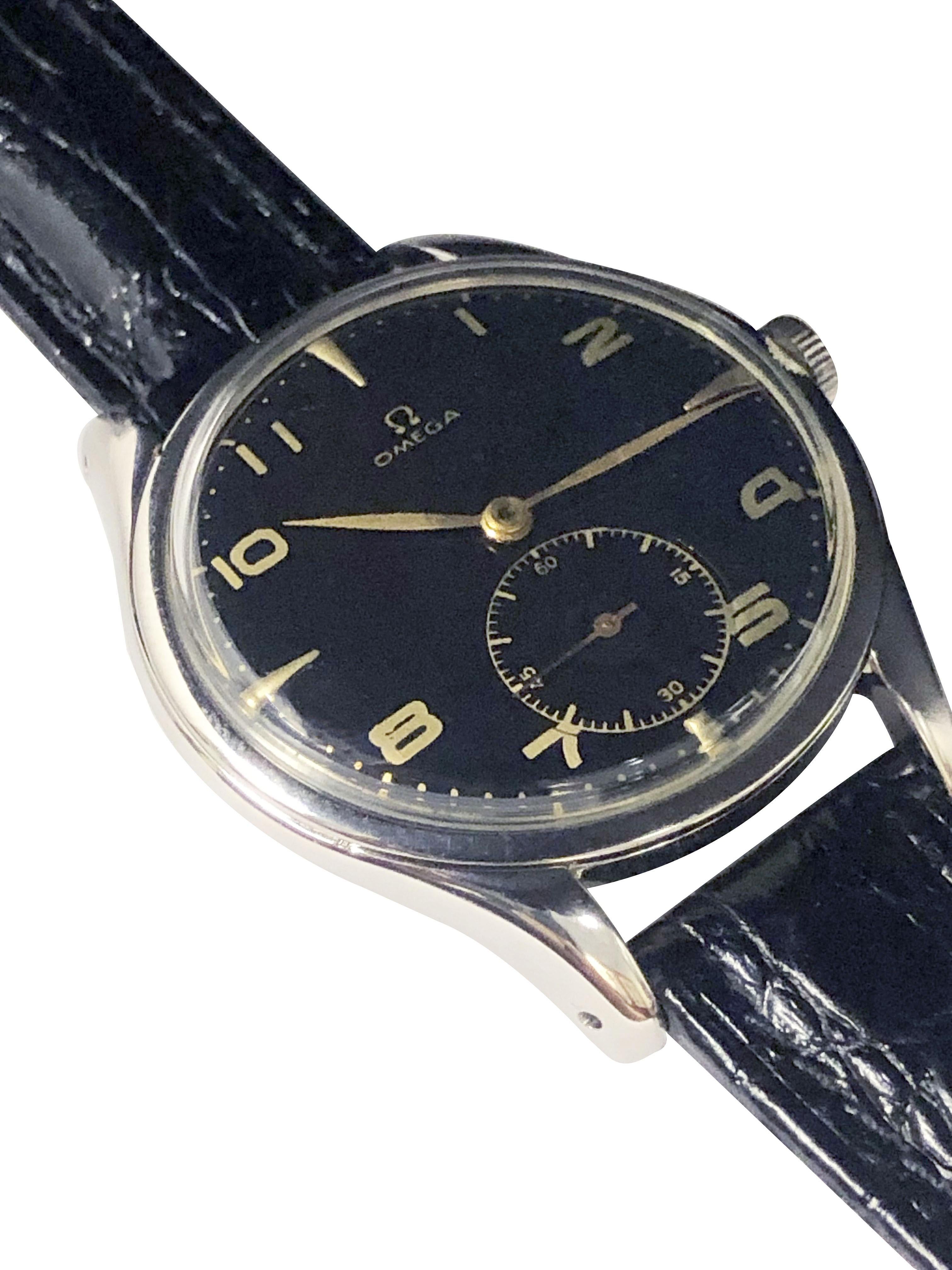 Circa late 1940s Omega Wrist Watch, 38.5 M.M Stainless Steel 3 piece case, 17 Jewel Caliber 260 Mechanical, Manual Wind Movement, Omega logo Crown, very old and Mint condition refinished Black Dial with raised and printed Gold Numerals and markers