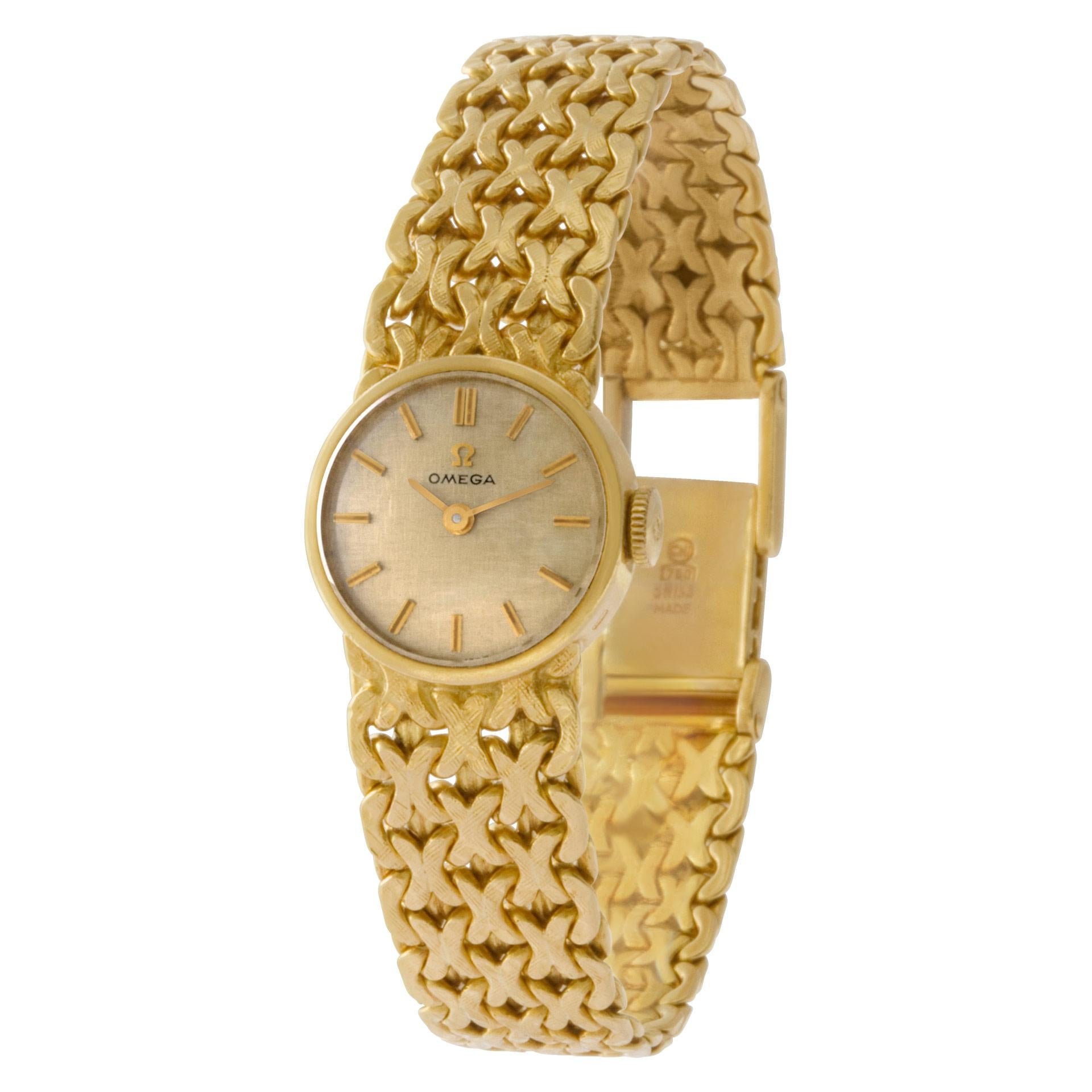 Omega in 18k on a woven band. Quartz. 17 mm case size. Ref 7173. Circa 1980's Fine Pre-owned Omega Watch.   Certified preowned Vintage Omega Vintage 7173 watch is made out of yellow gold on a 18k bracelet with a 18k Clasp buckle. This Omega watch