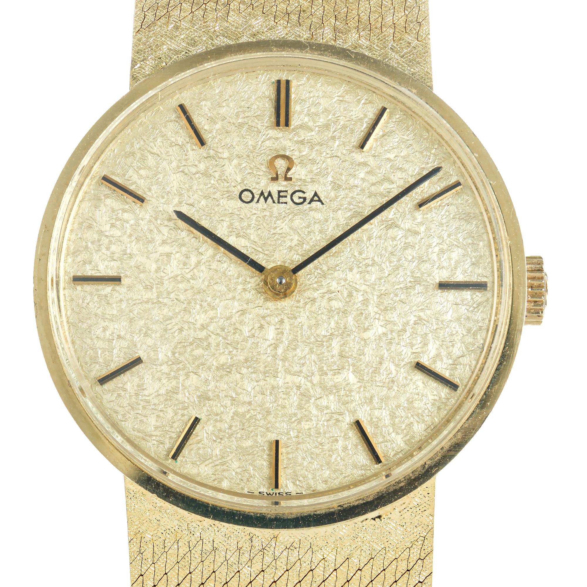 Vintage 1960's unisex Omega wrist watch. Stylish mid-century 14k yellow gold round bezel dress wristwatch complimented by a beautiful 7.25 inch mesh band which matches the dial. Classic 1960's vintage style. 

Length: 28.65mm
Width: 28.51mm
Band
