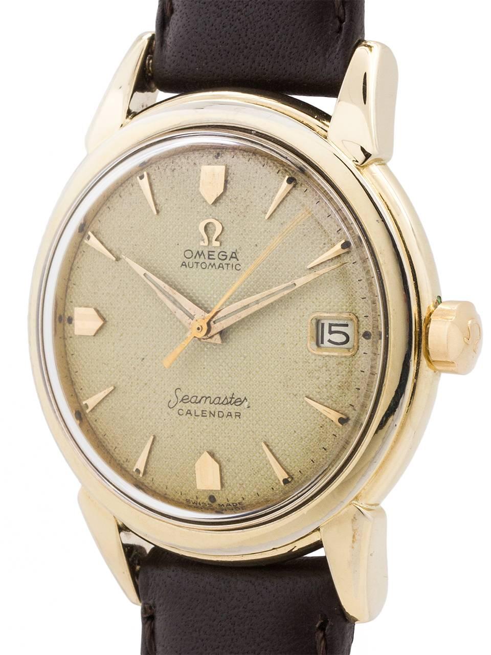 
Vintage Omega Seamaster Calendar automatic ref 6275 circa 1956. Featuring a 35 X 43mm diameter 14K gold filled case with wide, stepped bezel and gold filled case back. With original, aged, honeycomb champagne dial with eccentric design applied gold