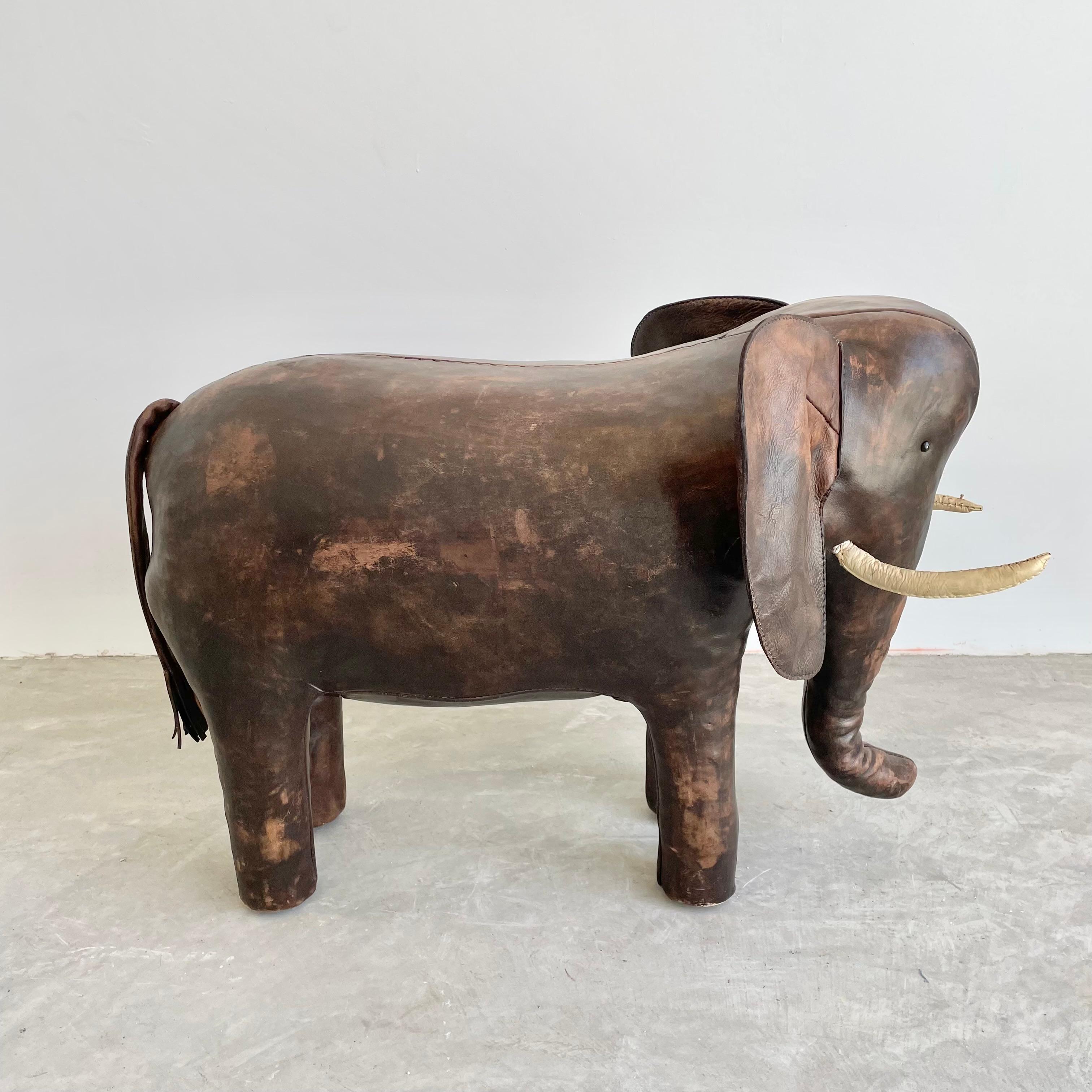 **DEPOSIT TWO**
Rare leather elephant by Omersa. Heavy, functional stool, strong enough for an adult. Made in England, Circa 1960s. Beautiful vintage coloring and patina. Wear as shown. Great sculptural seat. Fun piece of usable art for the home.