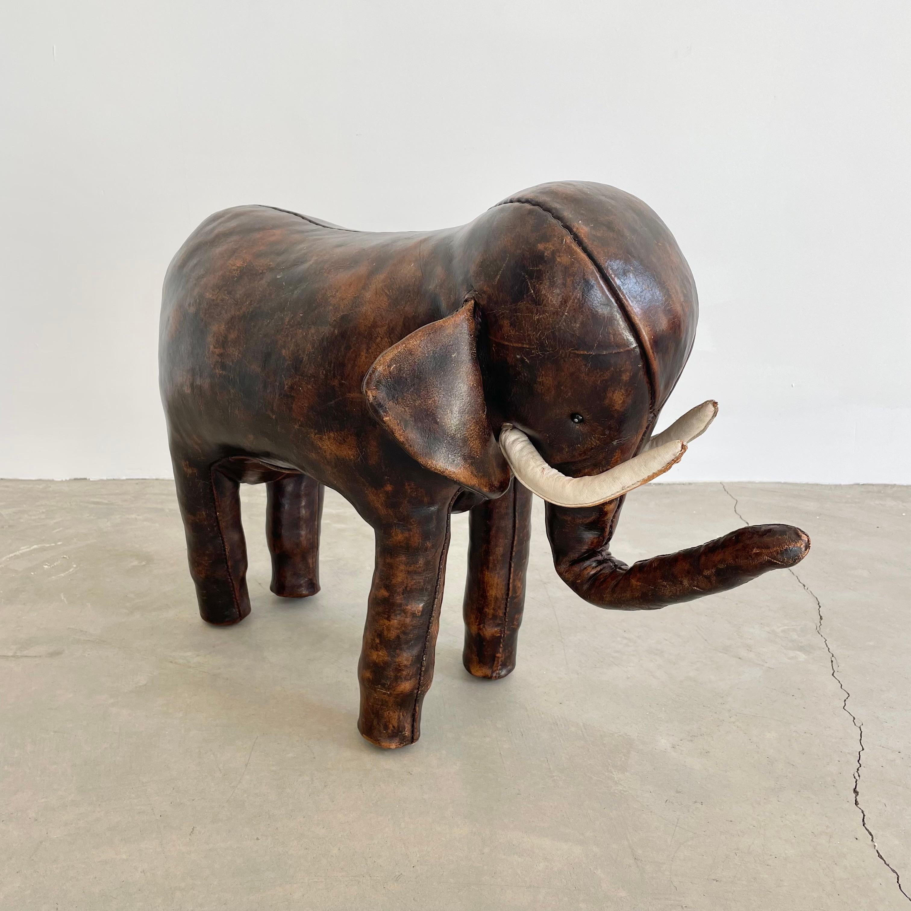 Fabulous original leather elephant footstool by Dimitri Omersa for Liberty’s of London, distributed by Abercrombie & Fitch circa 1963. This example is signed with the circle 'A&F CO' embossed stamp under one ear, has the early nail heads under its