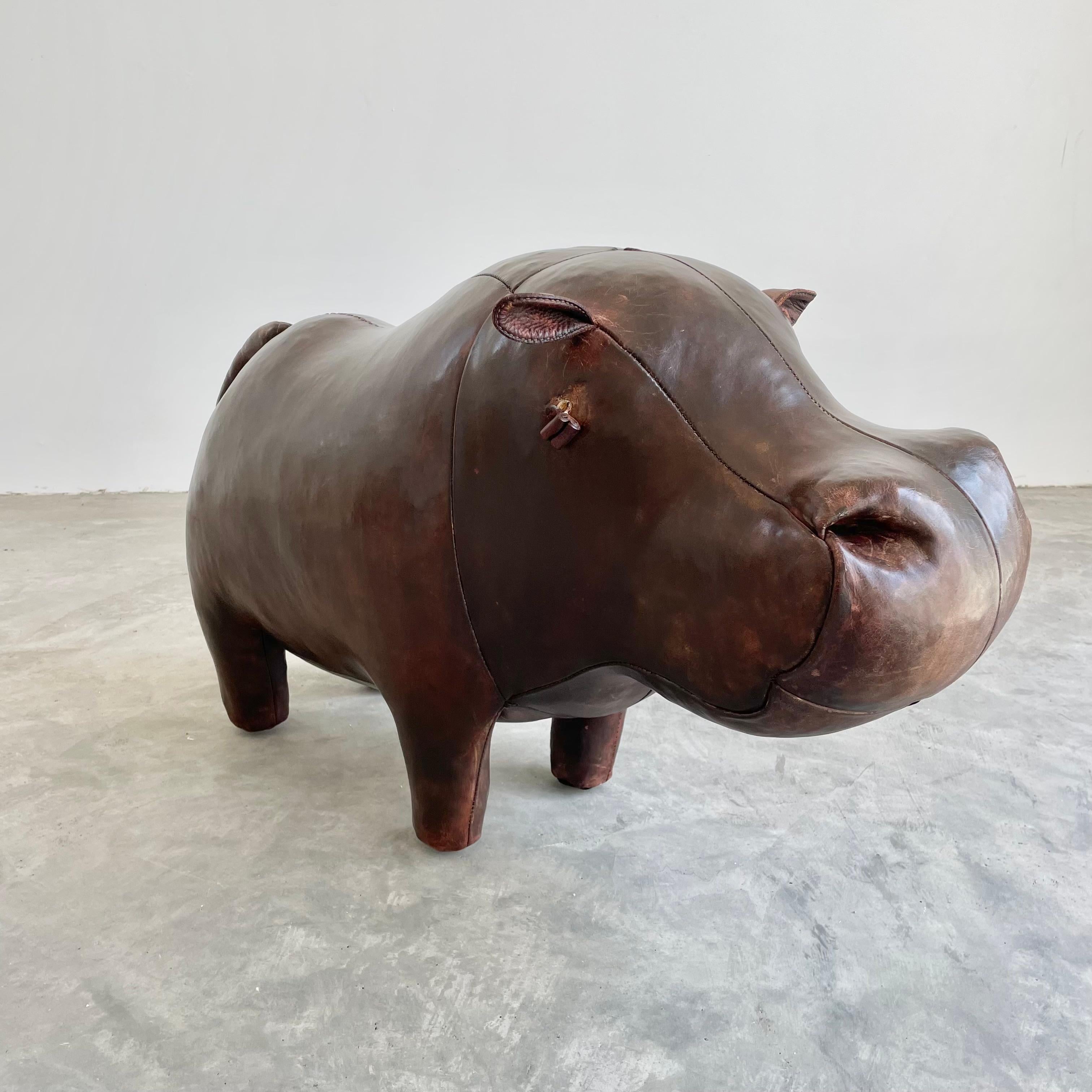 Beautiful large leather hippopotamus by Omersa. Heavy, functional stool, strong enough for an adult. Made in England, Circa 1960s. Beautiful vintage coloring and patina. No tears or rips. Great sculptural seat. Fun piece of usable art for the home.
